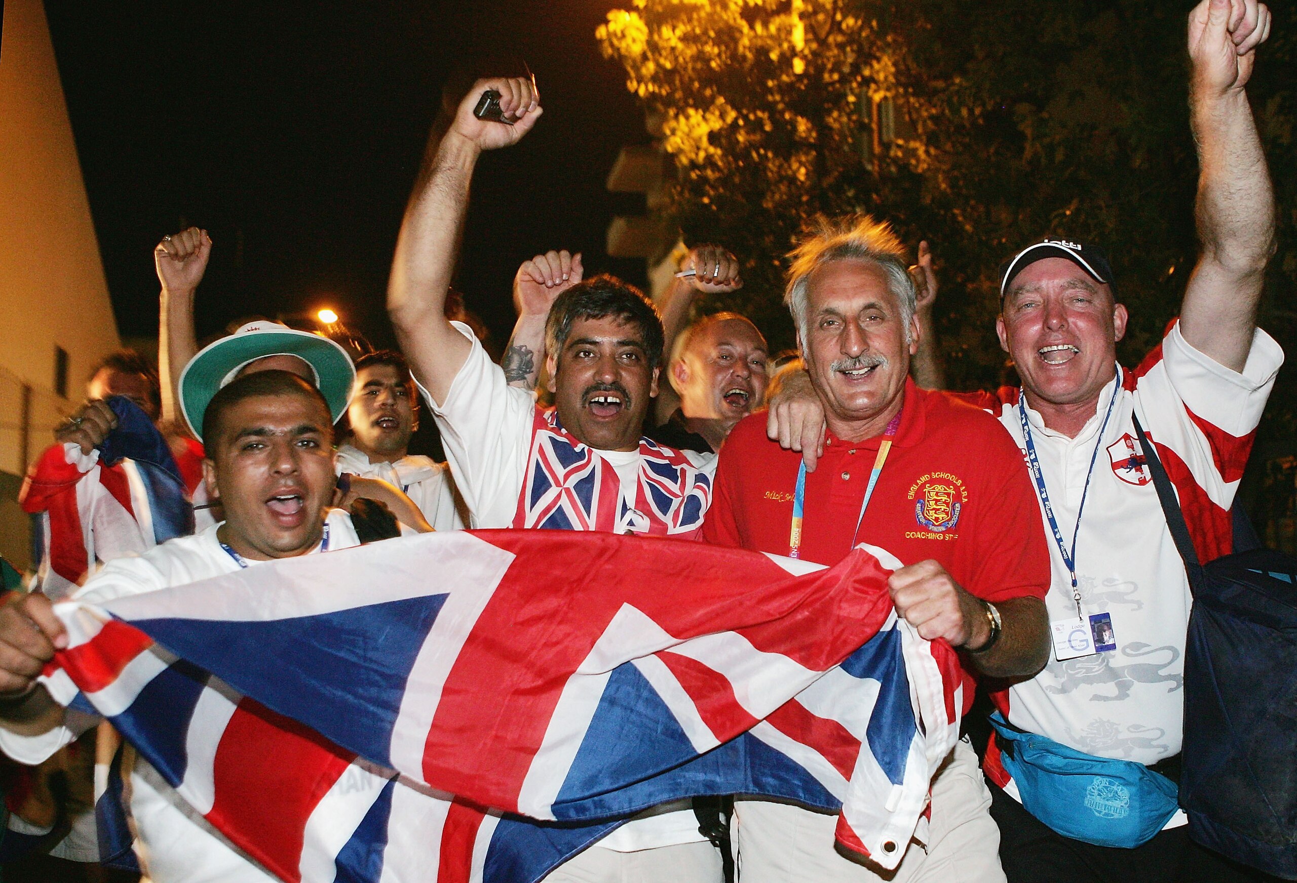 ATHENS - AUGUST 27:  Shajaad Khan, father of Amir Khan of Great Britain, wearing a Union Jack vest, celebrates after Amir Khan defeated Serik Yeleuov of Kazakstan in the men's boxing 60 kg semifinal bout on August 27, 2004 during the Athens 2004 Summer Ol