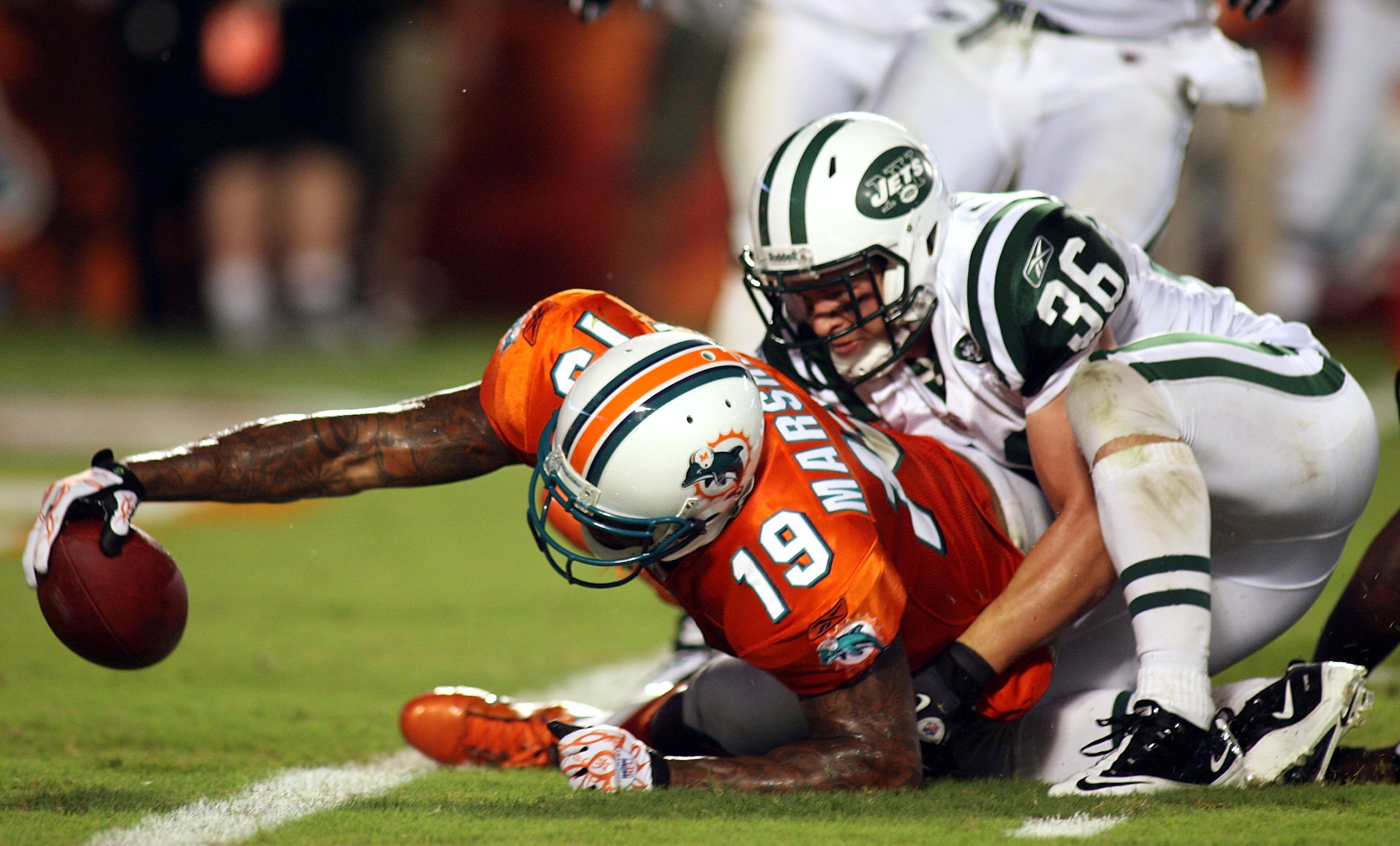 MIAMI - SEPTEMBER 26:  Receiver Brandon Marshall #19 of the Miami Dolphins scores a touchdown against the New York Jets at Sun Life Stadium on September 26, 2010 in Miami, Florida.  (Photo by Marc Serota/Getty Images)