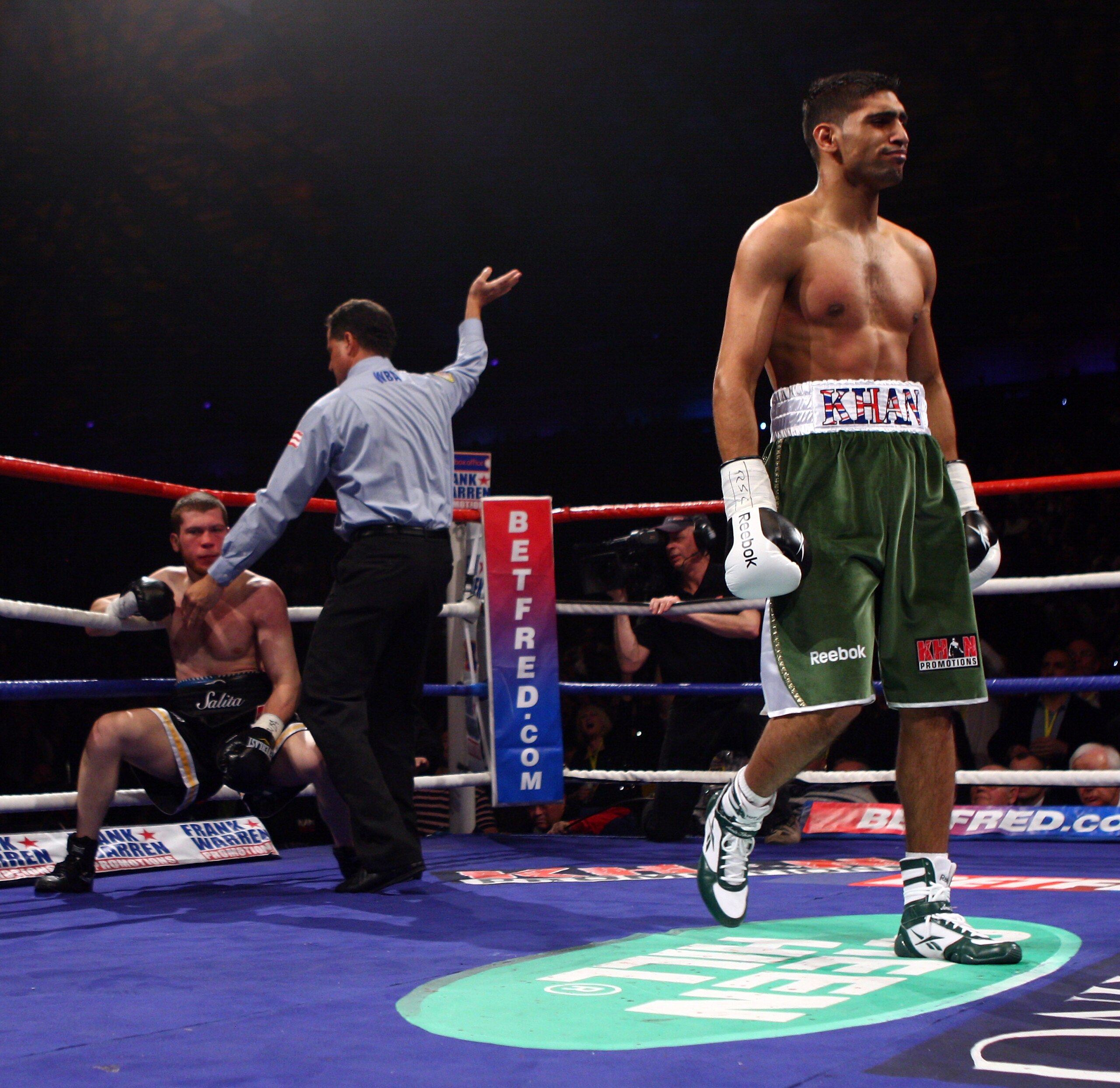 NEWCASTLE UPON TYNE, ENGLAND - DECEMBER 05:  Amir Khan knocks down Dmitriy Salita of the U.S. for the third and final time in the first round to retain his WBA Light Welterweight title on December 5, 2009 in Newcastle upon Tyne, England.  (Photo by John G