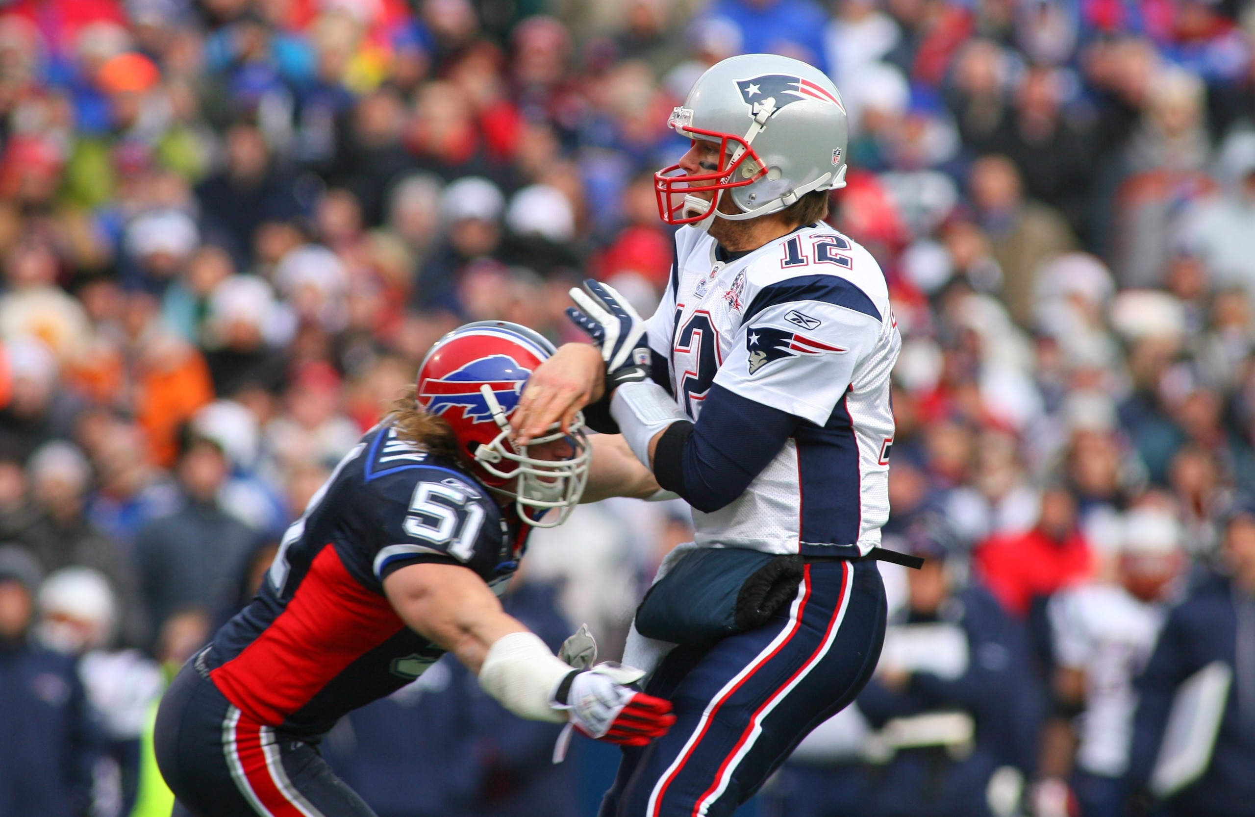 ORCHARD PARK, NY - DECEMBER 20: Tom Brady #12 of the New England Patriots throws a pass as  Paul Posluszny #51 of the Buffalo Bills defends during the game at Ralph Wilson Stadium on December 20, 2009 in Orchard Park, New York. (Photo by: Rick Stewart/Get