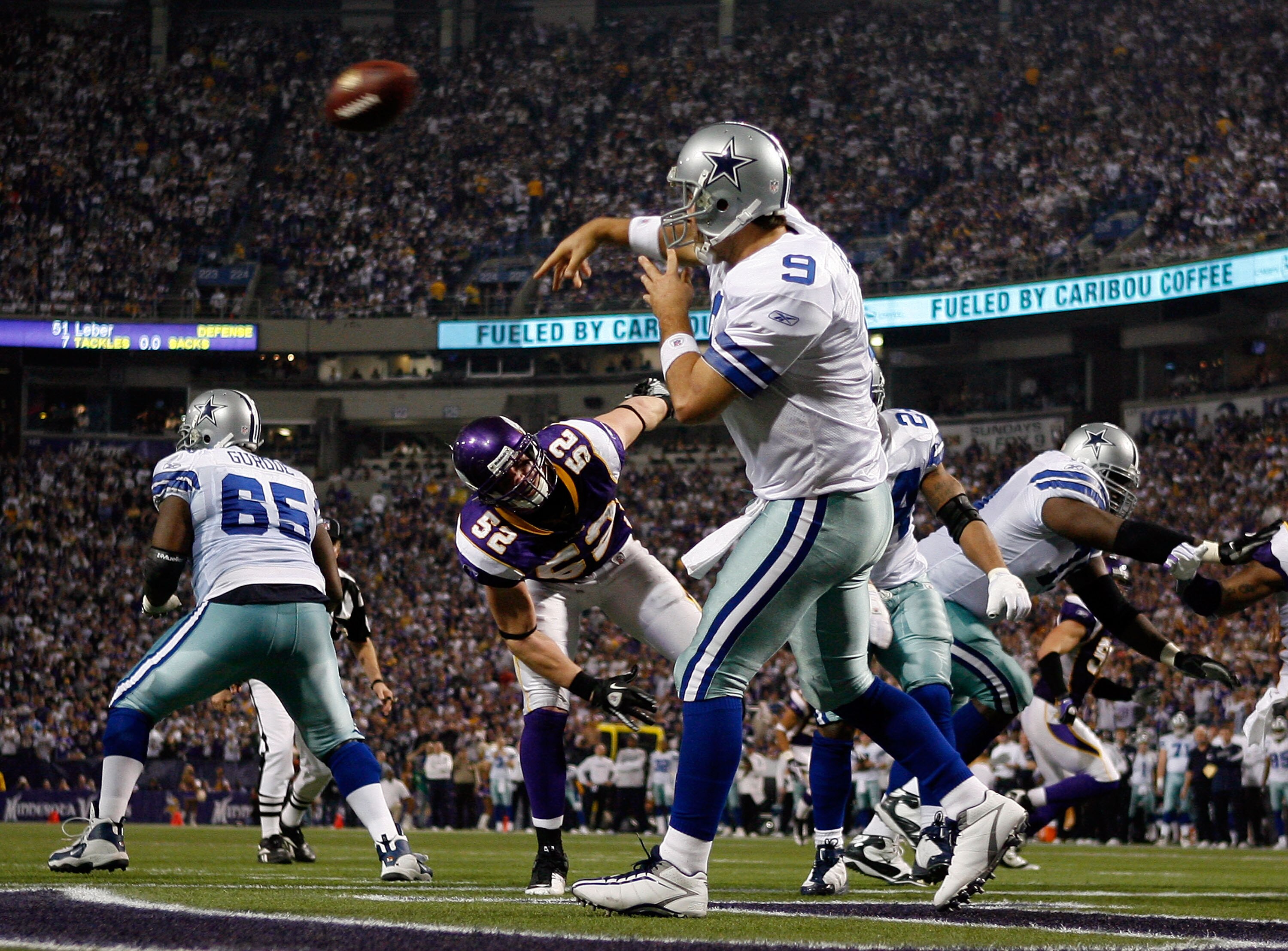 MINNEAPOLIS - JANUARY 17:  Quarterback Tony Romo #9 of the Dallas Cowboys throws a pass as he comes under pressure from Chad Greenway #52 of the Minnesota Vikings during the third quarter of the NFC Divisional Playoff Game at Hubert H. Humphrey Metrodome 