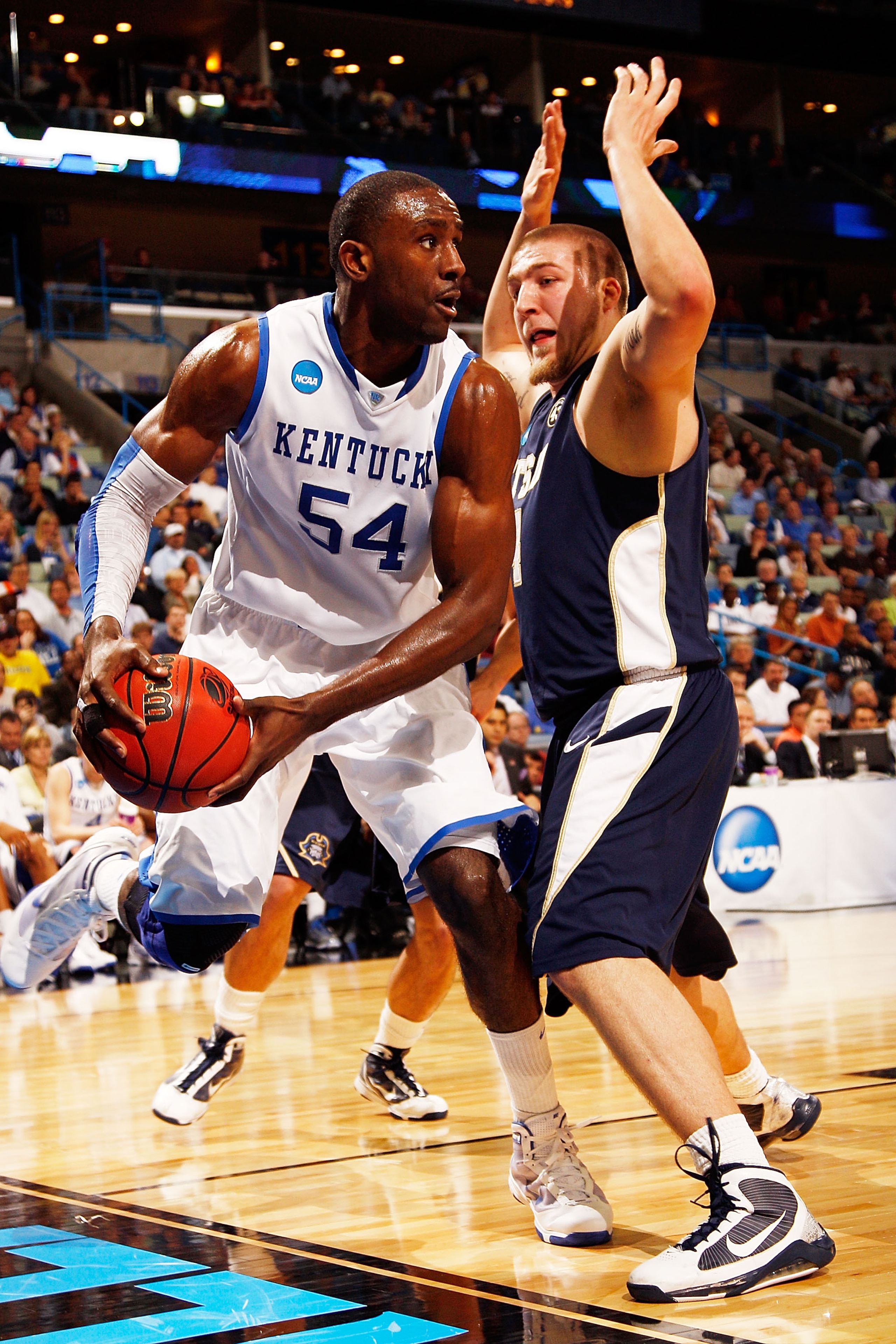 NEW ORLEANS - MARCH 18:  Patrick Patterson #54 of the Kentucky Wildcats looks to pass the ball around J.C. Ward #44 of the East Tennessee State Buccaneers during the first round of the 2010 NCAA men's basketball tournament at the New Orleans Arena on Marc