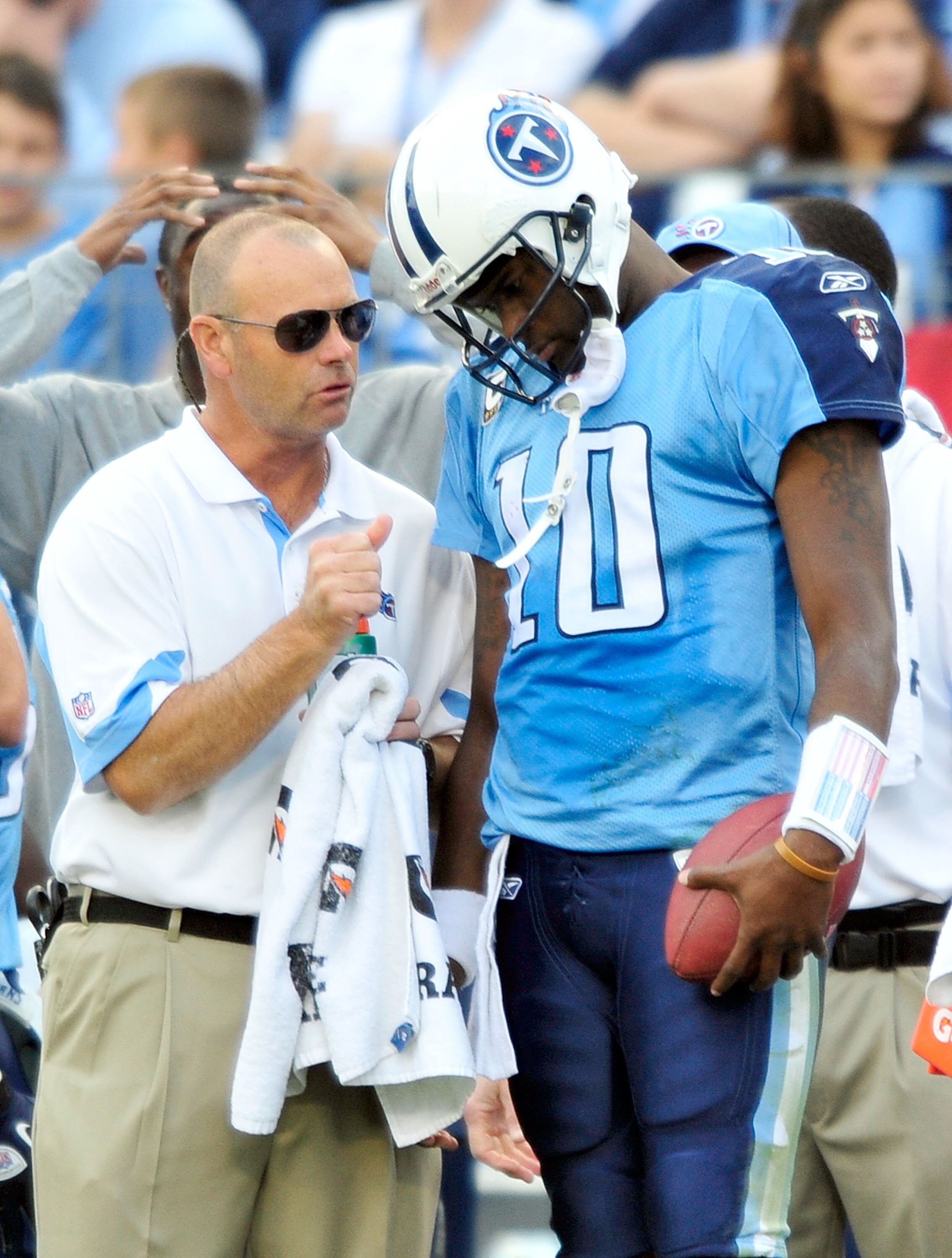 NASHVILLE, TN - NOVEMBER 21:  Quarterback Vince Young #11 of the Tennessee Titans talks with a member of the training staff after leaving a game against the Washington Redskins at LP Field on November 21, 2010 in Nashville, Tennessee. The Redskins won 19-