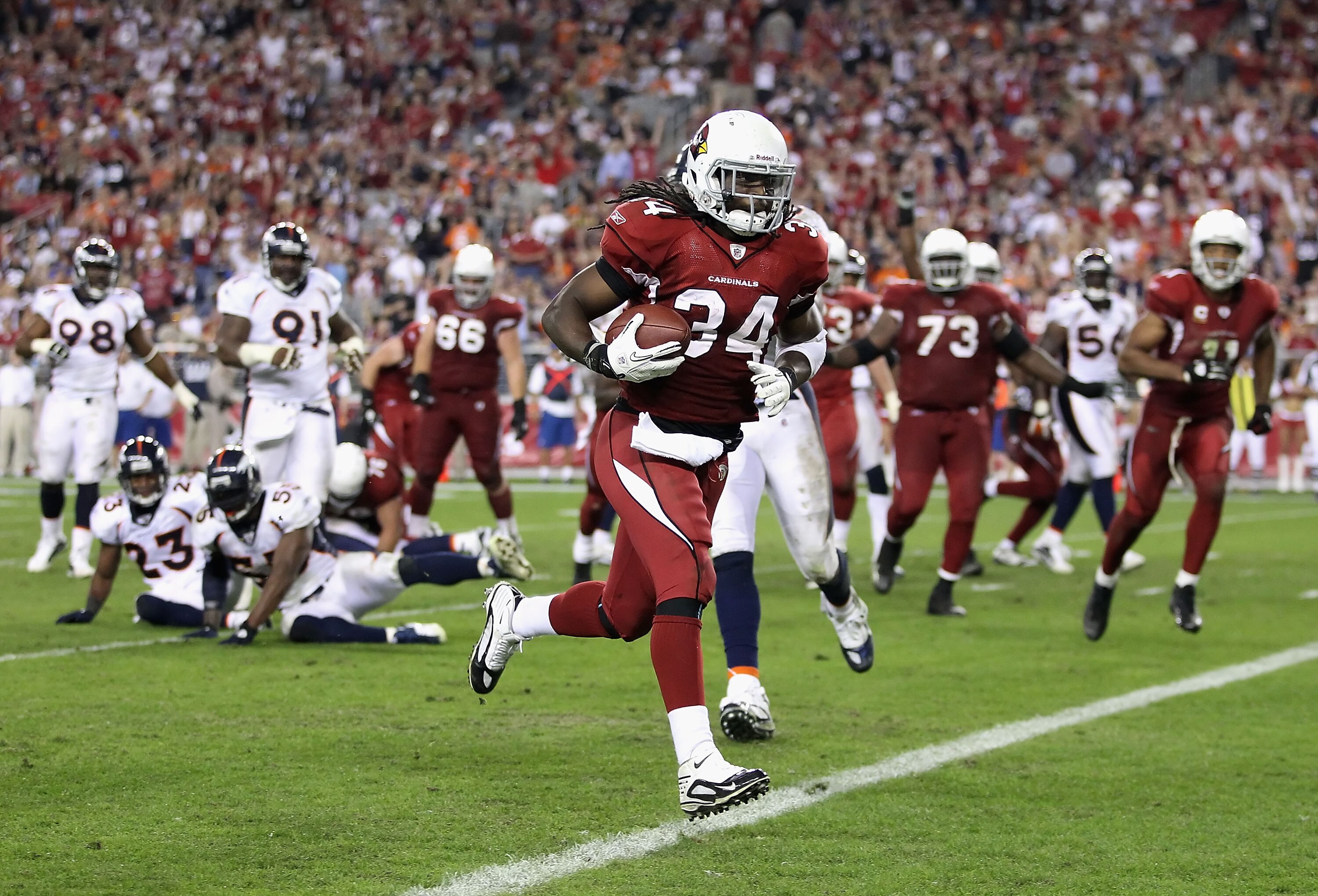 GLENDALE, AZ - DECEMBER 12:  Runningback Tim Hightower #34 of the Arizona Cardinals scores a 8 yard rushing touchdown against the Denver Broncos during the fourth quarter of the NFL game at the University of Phoenix Stadium on December 12, 2010 in Glendal