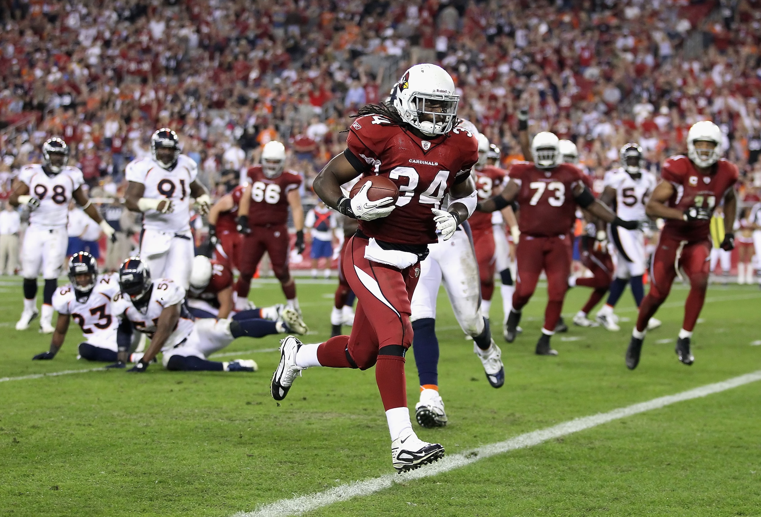 GLENDALE, AZ - DECEMBER 12:  Runningback Tim Hightower #34 of the Arizona Cardinals scores a 8 yard rushing touchdown against the Denver Broncos during the fourth quarter of the NFL game at the University of Phoenix Stadium on December 12, 2010 in Glendal