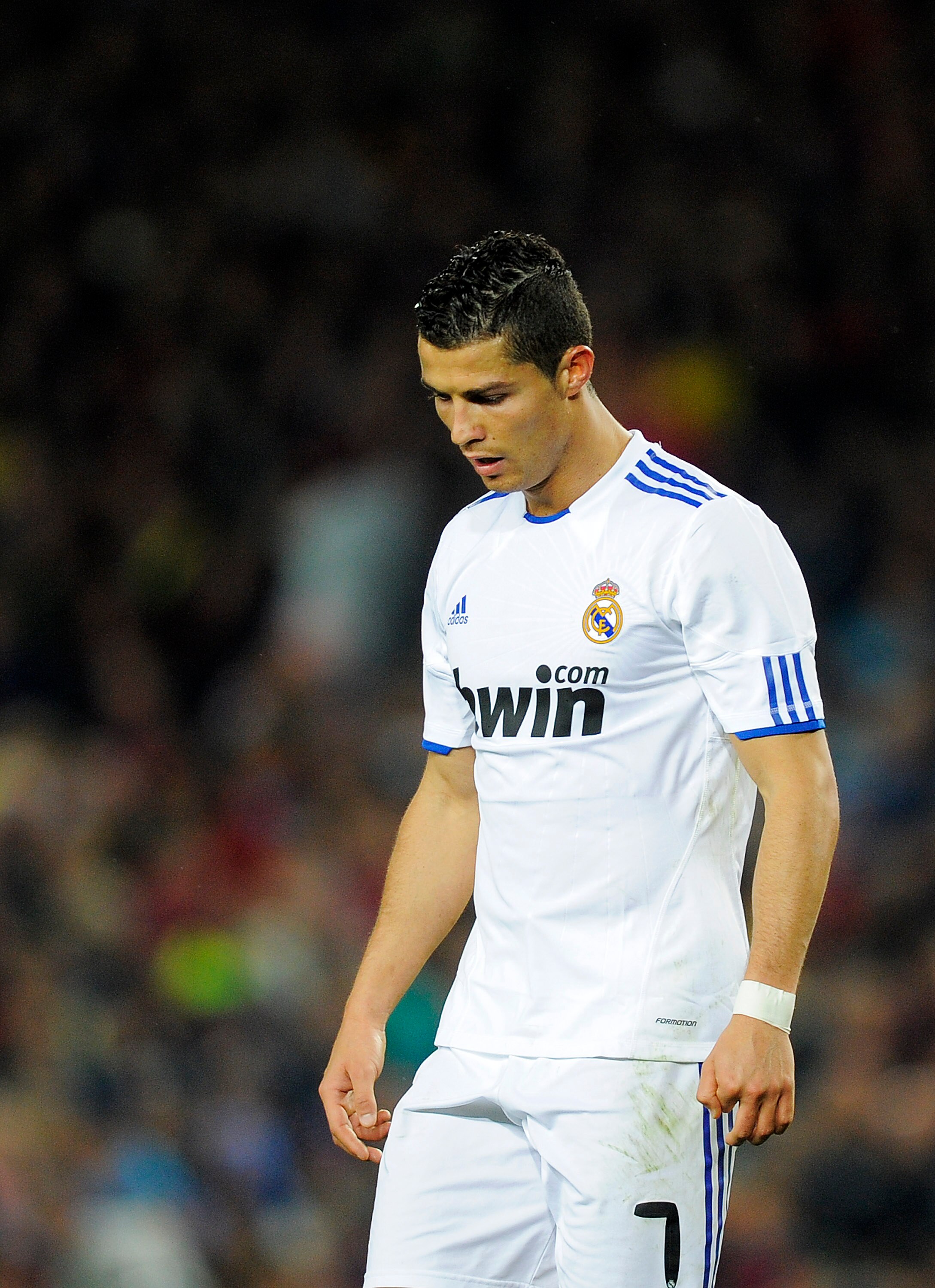 BARCELONA, SPAIN - NOVEMBER 29:  Cristiano Ronaldo of Real Madrid looks down during the La Liga match between Barcelona and Real Madrid at the Camp Nou Stadium on November 29, 2010 in Barcelona, Spain. Barcelona won the match 5-0.  (Photo by David Ramos/G