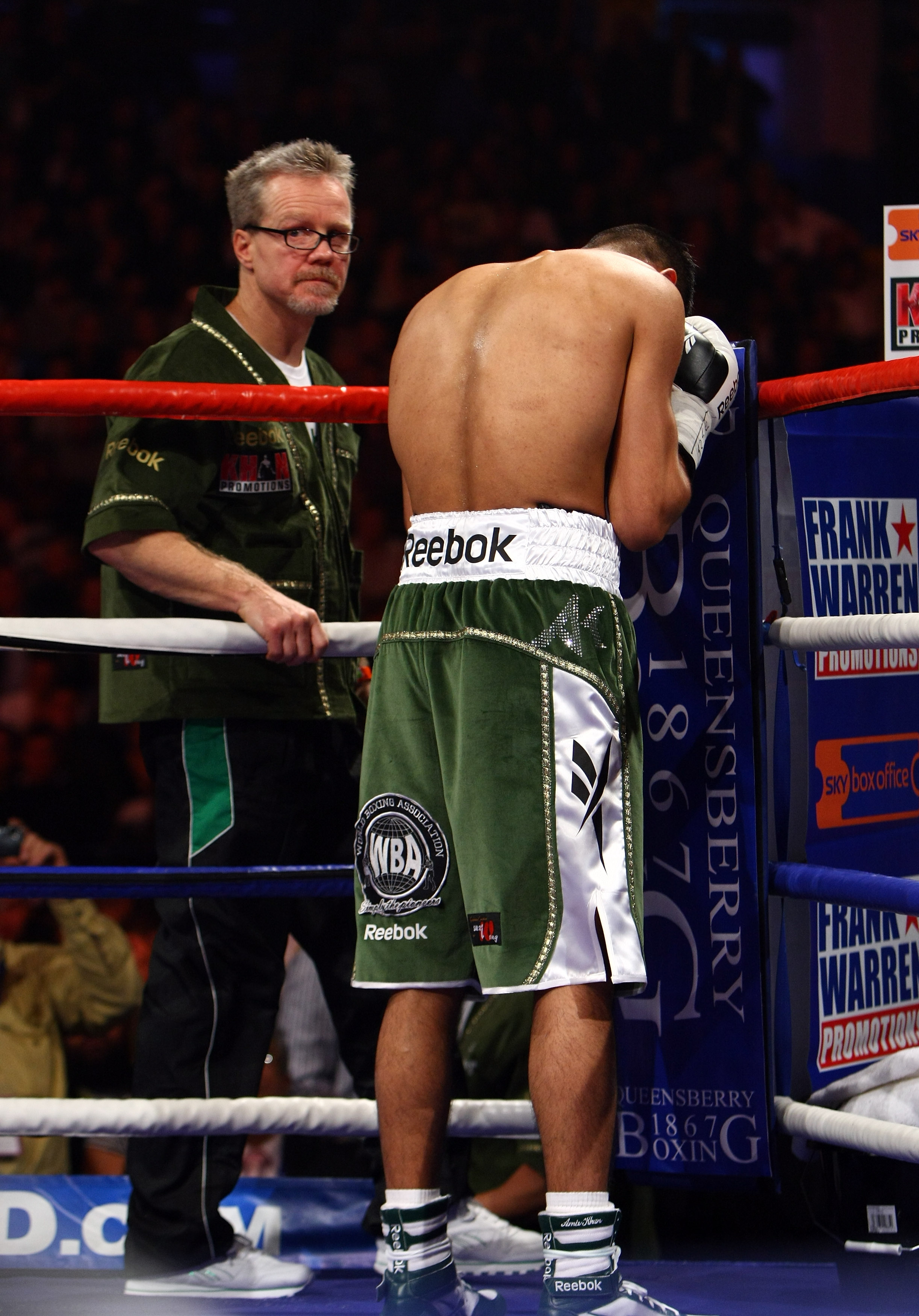 NEWCASTLE UPON TYNE, ENGLAND - DECEMBER 05:  Amir Khan says a prayer watched by his trainer Freddie Roach (L) before his fight against Dmitriy Salita of the U.S. for the WBA Light Welterweight title on December 5, 2009 in Newcastle upon Tyne, England.  (P