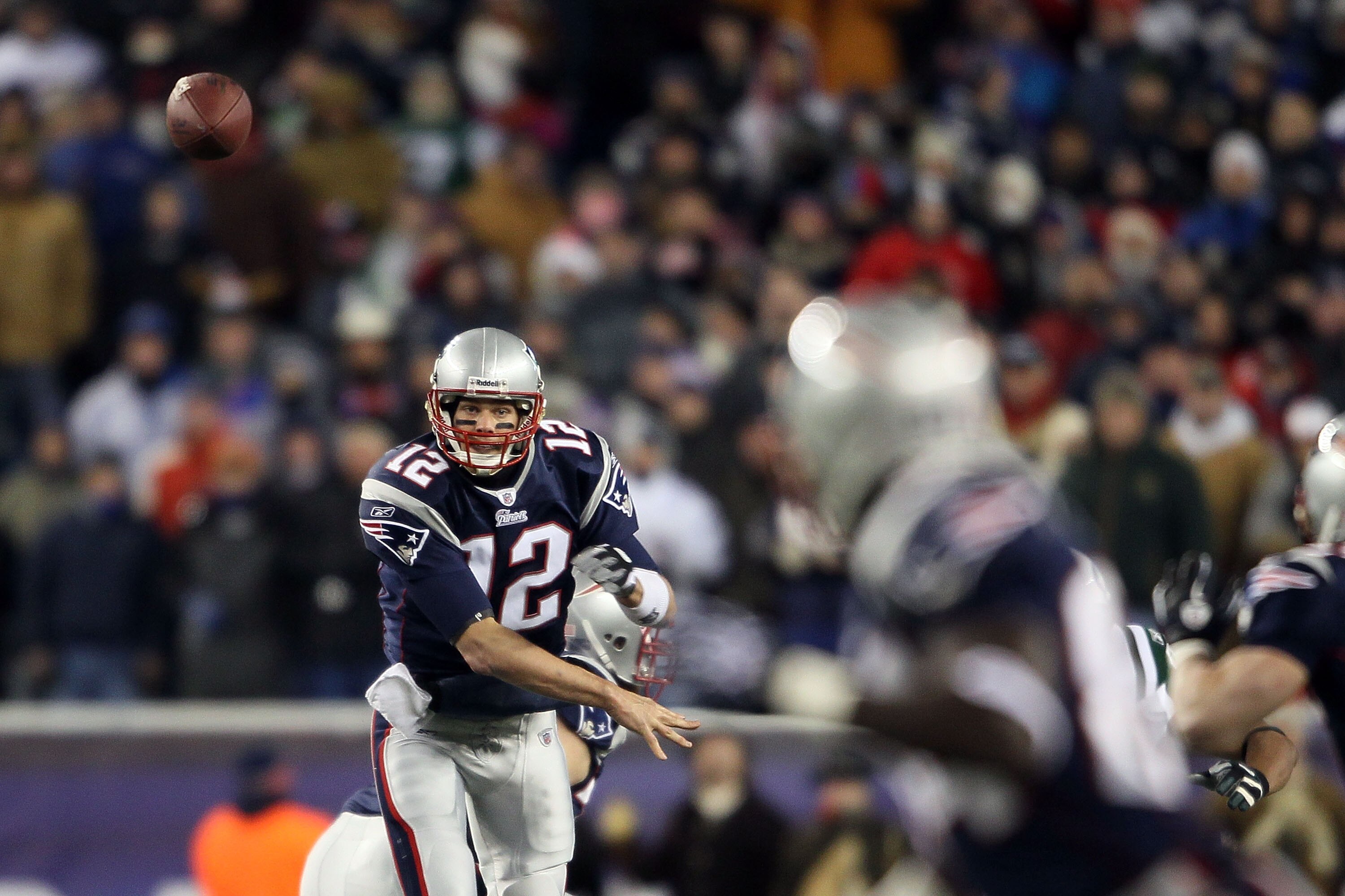 FOXBORO, MA - DECEMBER 06:  Tom Brady #12 of the New England Patriots throws a pass to Deion Branch #84 against the New York Jets at Gillette Stadium on December 6, 2010 in Foxboro, Massachusetts.  (Photo by Elsa/Getty Images)