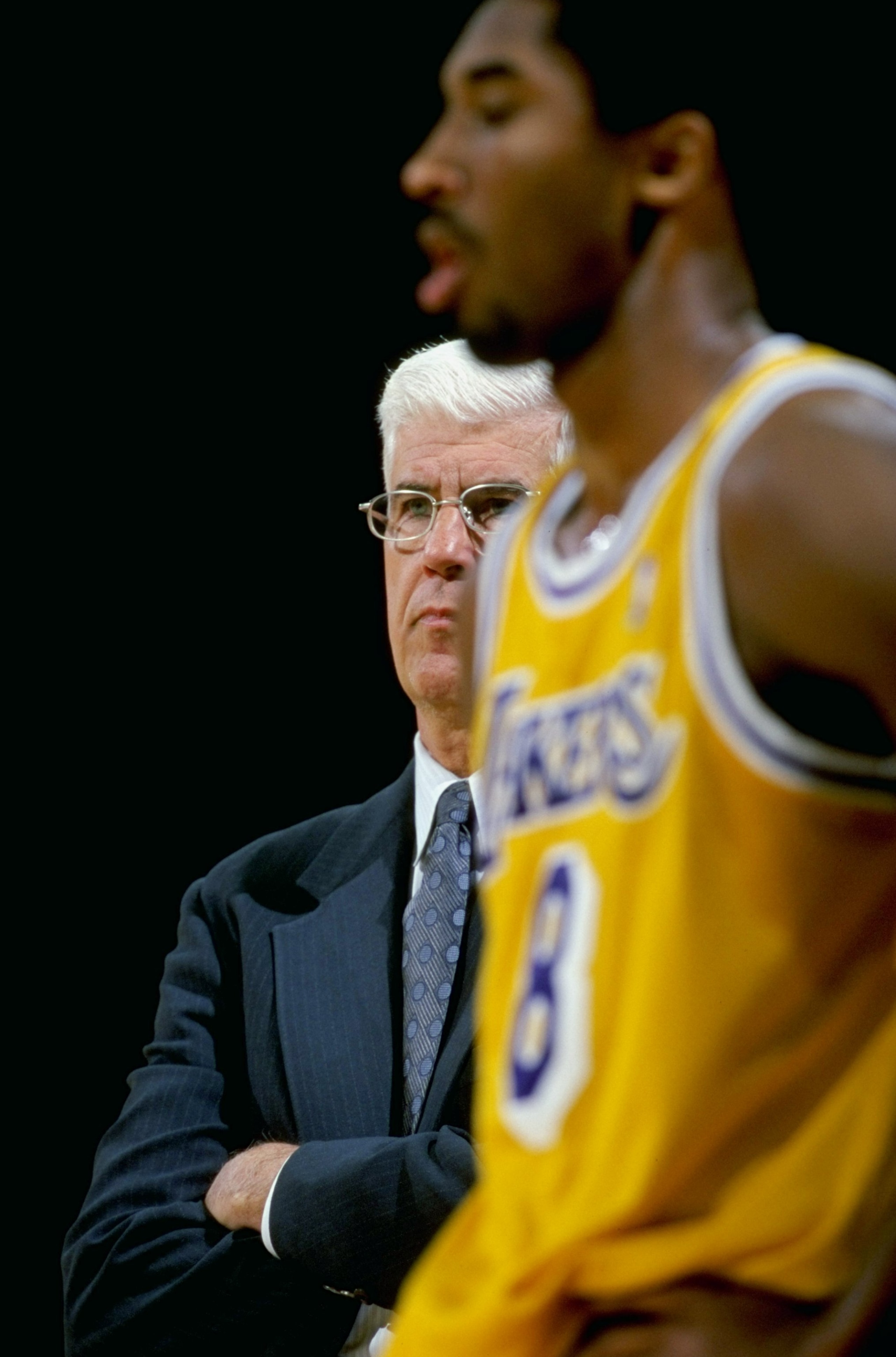 16 Feb 1999: Head coach Del Harris of the Los Angeles Lakers looks on from the sidelines as Kobe Bryant #8 walks on the court during the game against the Charlotte Hornets at the Great Western Forum in Inglewood, California. The Lakers defeated the Hornet 16 Feb 1999: Head coach Del Harris of the Los Angeles Lakers looks on from the sidelines as Kobe Bryant #8 walks on the court during the game against the Charlotte Hornets at the Great Western Forum in Inglewood, California. The Lakers defeated the Hornet