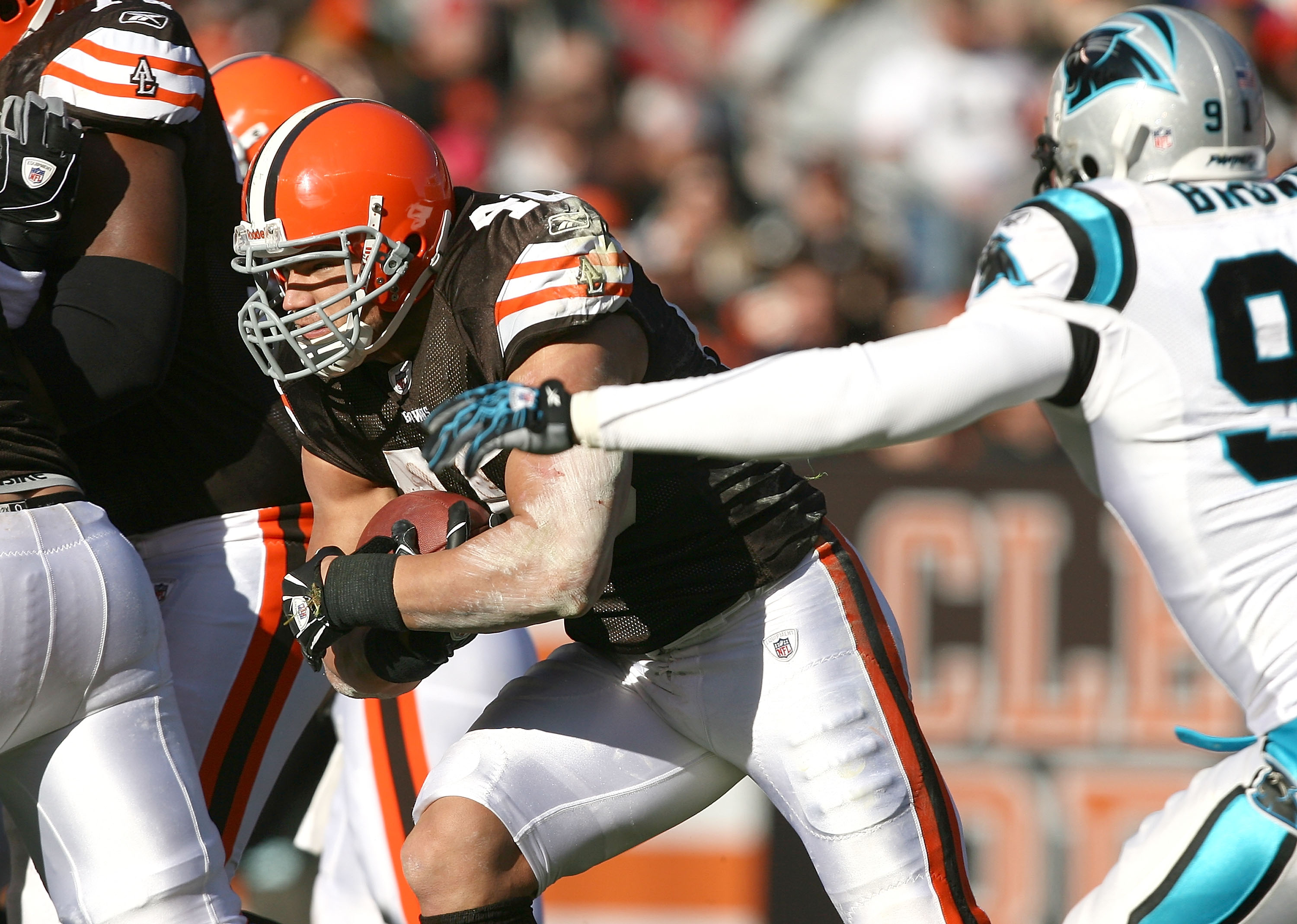 CLEVELAND - NOVEMBER 28:  Running back Peyton Hillis #40 of the Cleveland Browns scores a touchdown as he runs by defensive end Everette Brown #91 of the Carolina Panthers at Cleveland Browns Stadium on November 28, 2010 in Cleveland, Ohio.  (Photo by Mat