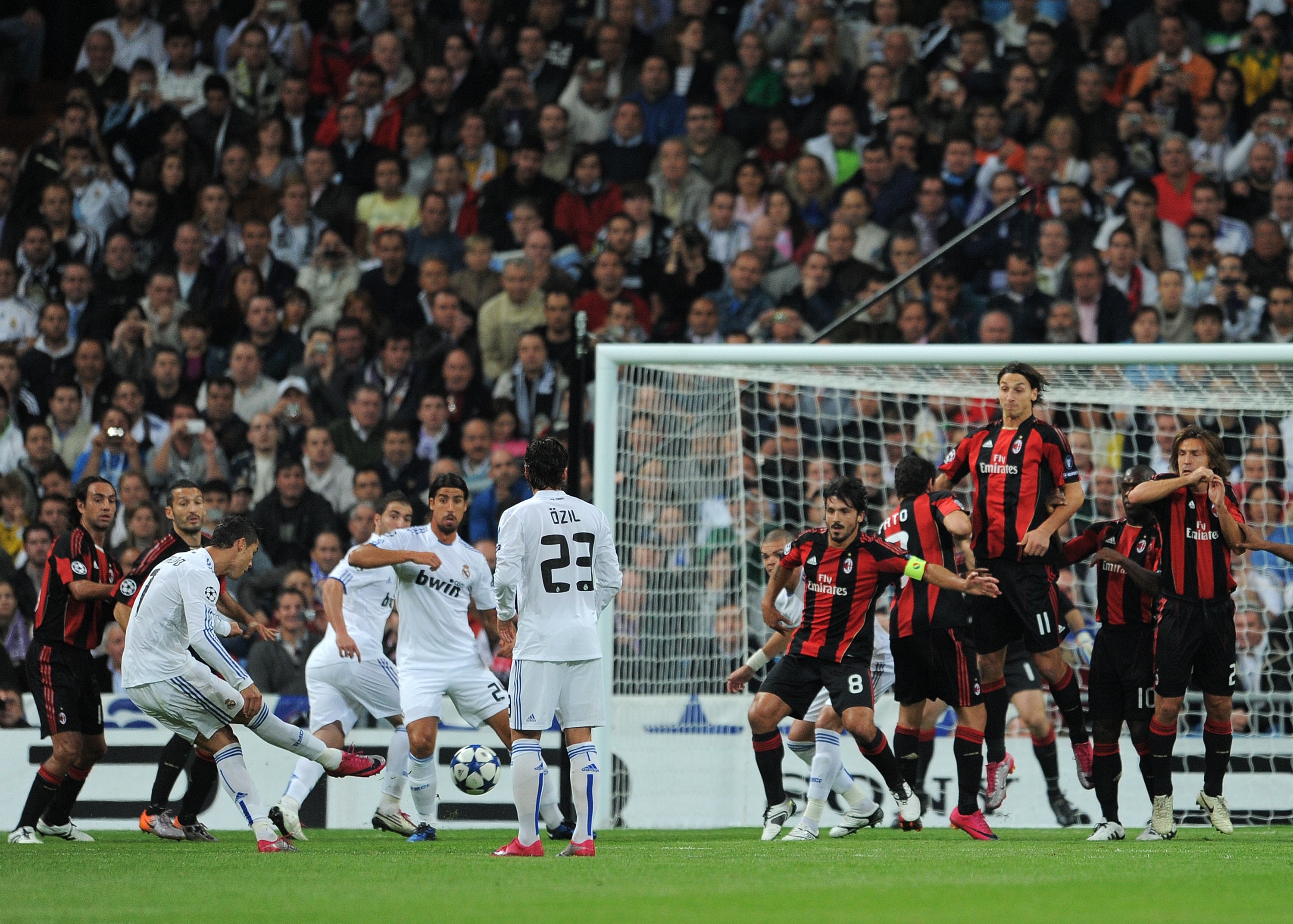 MADRID, SPAIN - OCTOBER 19:  Cristiano Ronaldo (L) of Real Madrid scores his sides opening goal from a free kick during the UEFA Champions League group G match between Real Madrid and AC Milan at the Estadio Santiago Bernabeu on October 19, 2010 in Madrid