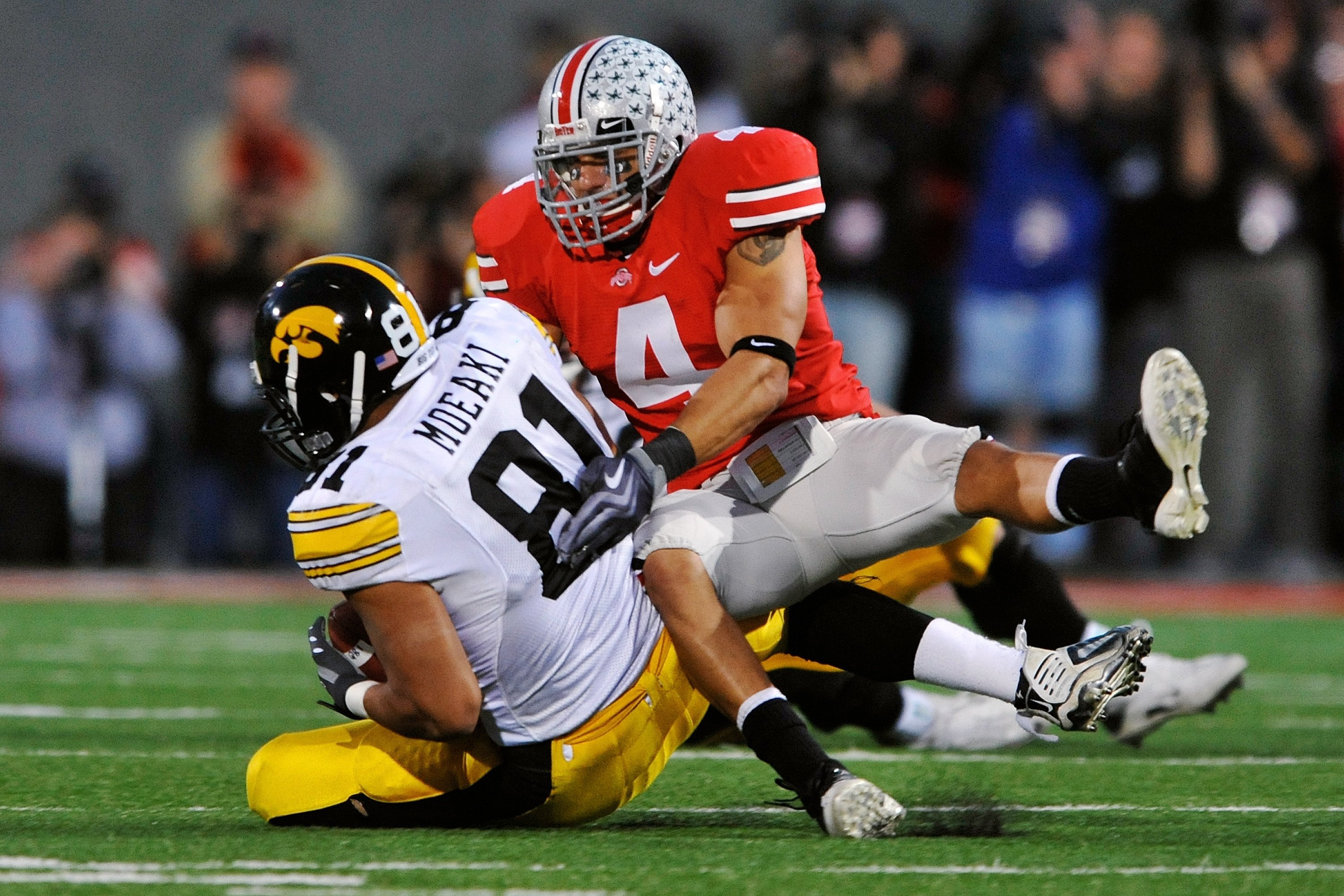COLUMBUS, OH - NOVEMBER 14:  Safety Kurt Coleman #4 of the Ohio State Buckeyes tackles tight end Tony Moeaki #81 of the Iowa Hawkeyes at Ohio Stadium on November 14, 2009 in Columbus, Ohio.  (Photo by Jamie Sabau/Getty Images)
