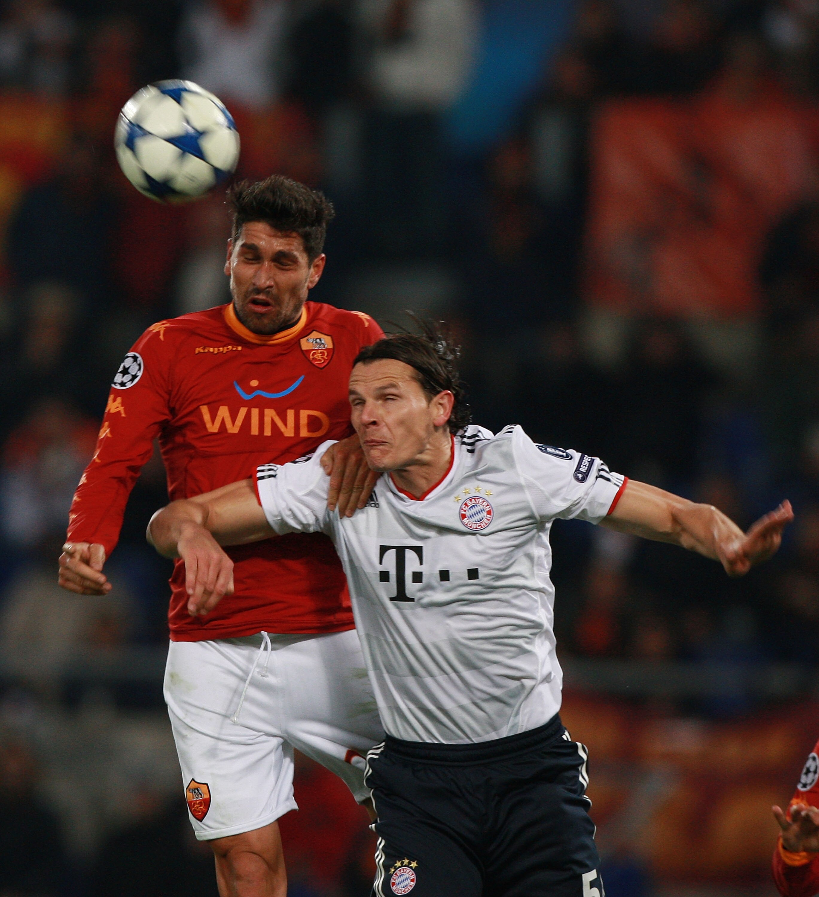 ROME - NOVEMBER 23:  Daniel Van Buyten (R) of FC Bayern Muenchen competes for the ball with Marco Borriello of AS Roma during the UEFA Champions League Group E match between AS Roma and FC Bayern Muenchen at Stadio Olimpico on November 23, 2010 in Rome, I