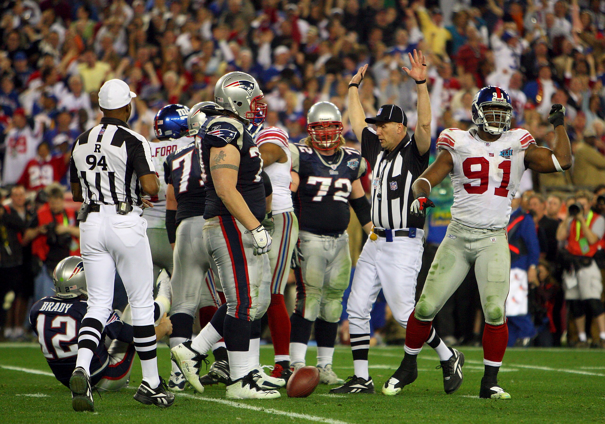GLENDALE, AZ - FEBRUARY 03:  Quarterback Tom Brady #12 of the New England Patriots lies on his back after being sacked by defensive end Justin Tuck #91 of the New York Giants in the third quarter during Super Bowl XLII on February 3, 2008 at the Universit