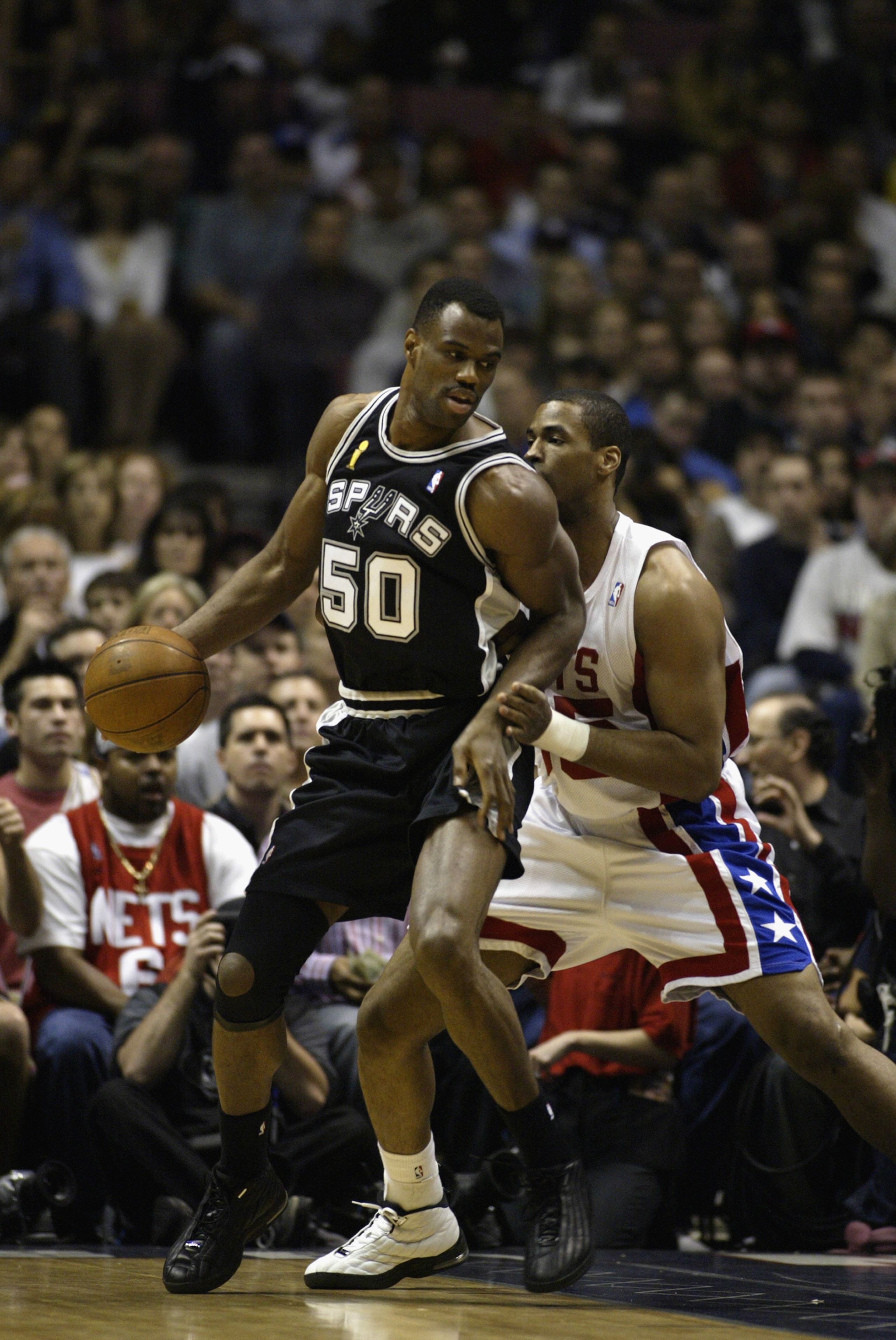 EAST RUTHERFORD, NJ - JUNE 13:  David Robinson #50 of the San Antonio Spurs is defended by Jason Collins #35 of the New Jersey Nets in game five of the 2003 NBA Finals on June 13, 2003 at the Continental Airlines Arena in East Rutherford, New Jersey.  The