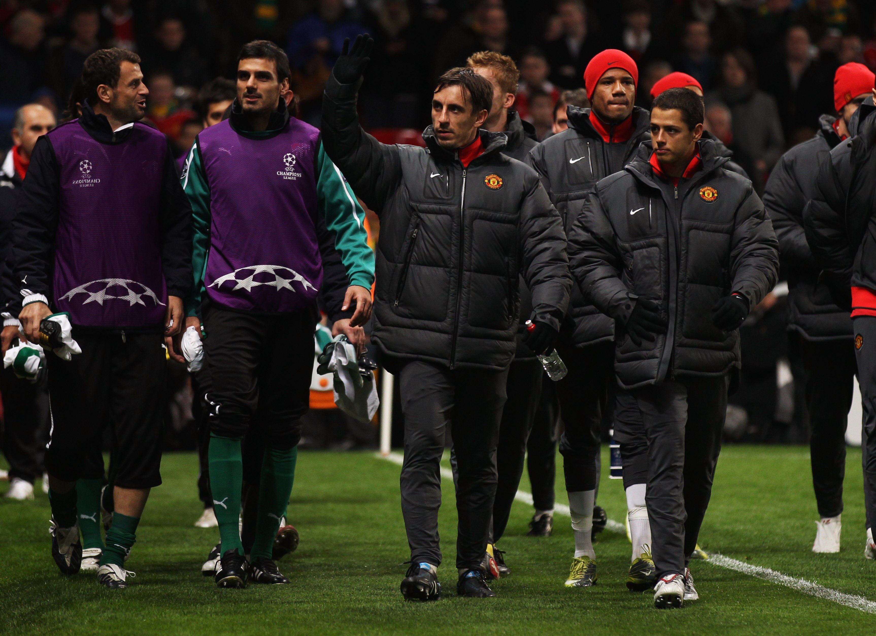 MANCHESTER, ENGLAND - OCTOBER 20:  Gary Neville and Javier Hernandez of Manchester United as he walk to the bench prior to the UEFA Champions League Group C  match between Manchester United and Bursaspor Kulubu at Old Trafford on October 20, 2010 in Manch