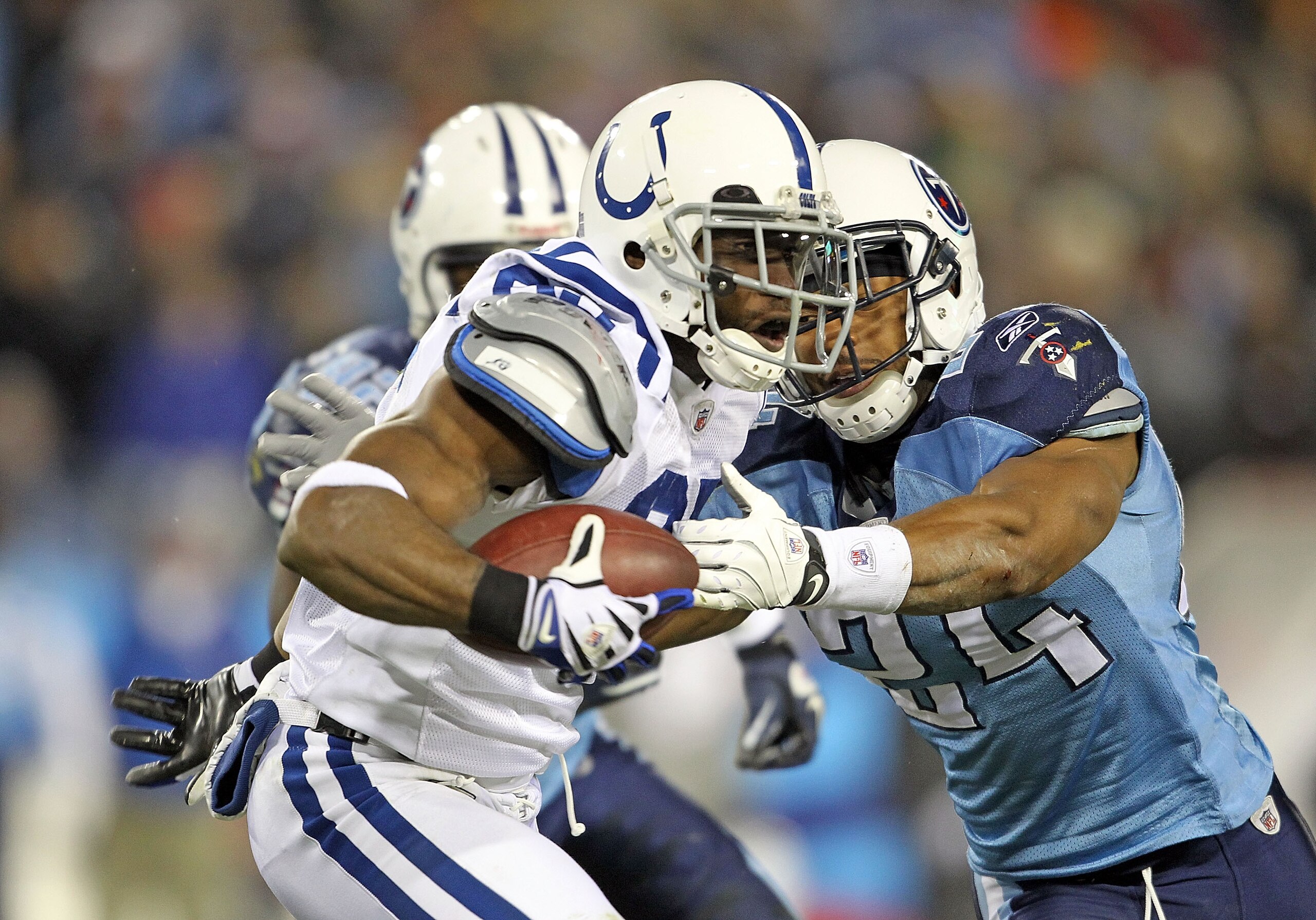 NASHVILLE, TN - DECEMBER 09:  Pierre Garcon #85 of the Indianapolis Colts runs with the ball after a reception while defended by Chris Hope #24  of the Tennessee Titans during the NFL game at LP Field on December 9, 2010 in Nashville, Tennessee.  (Photo b