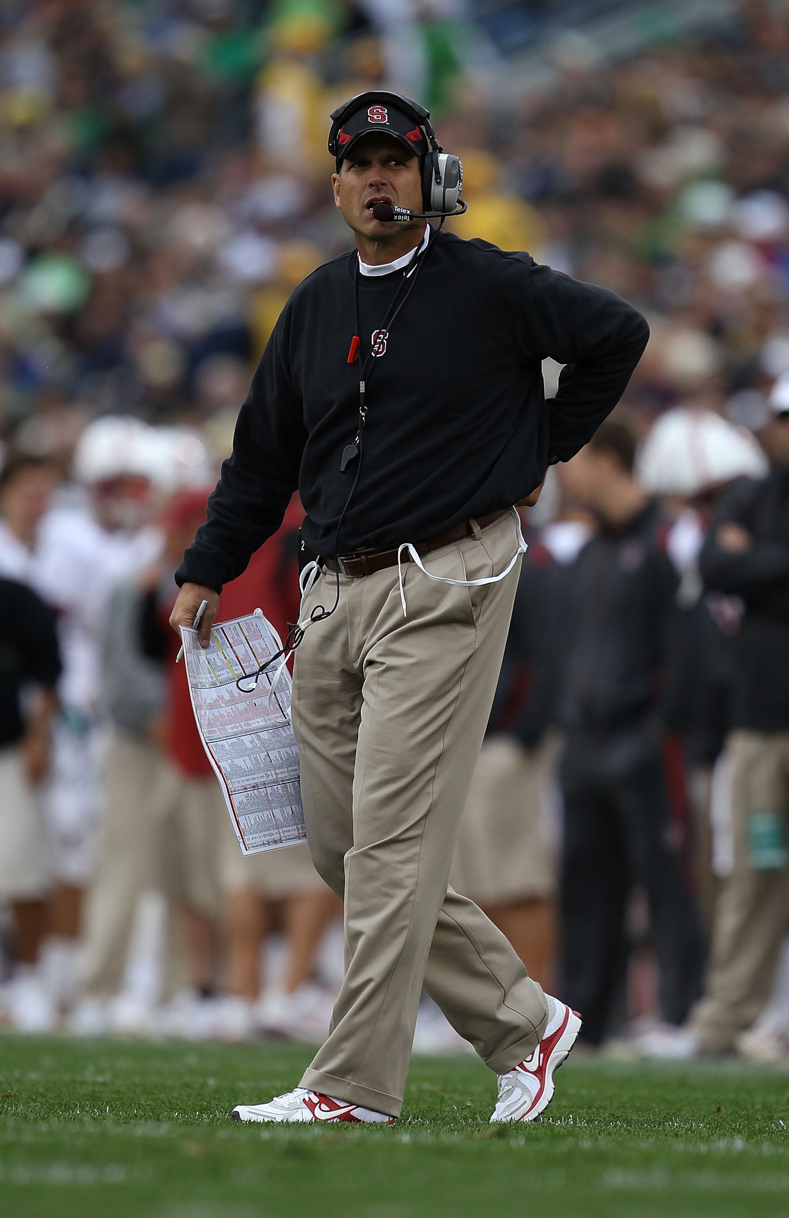 SOUTH BEND, IN - SEPTEMBER 25: Head coach Jim Harbaugh of the Stanford Cardinal looks at the scoreboard during a time out against the Notre Dame Fighting Irish at Notre Dame Stadium on September 25, 2010 in South Bend, Indiana. Stanford defeated Notre Dam