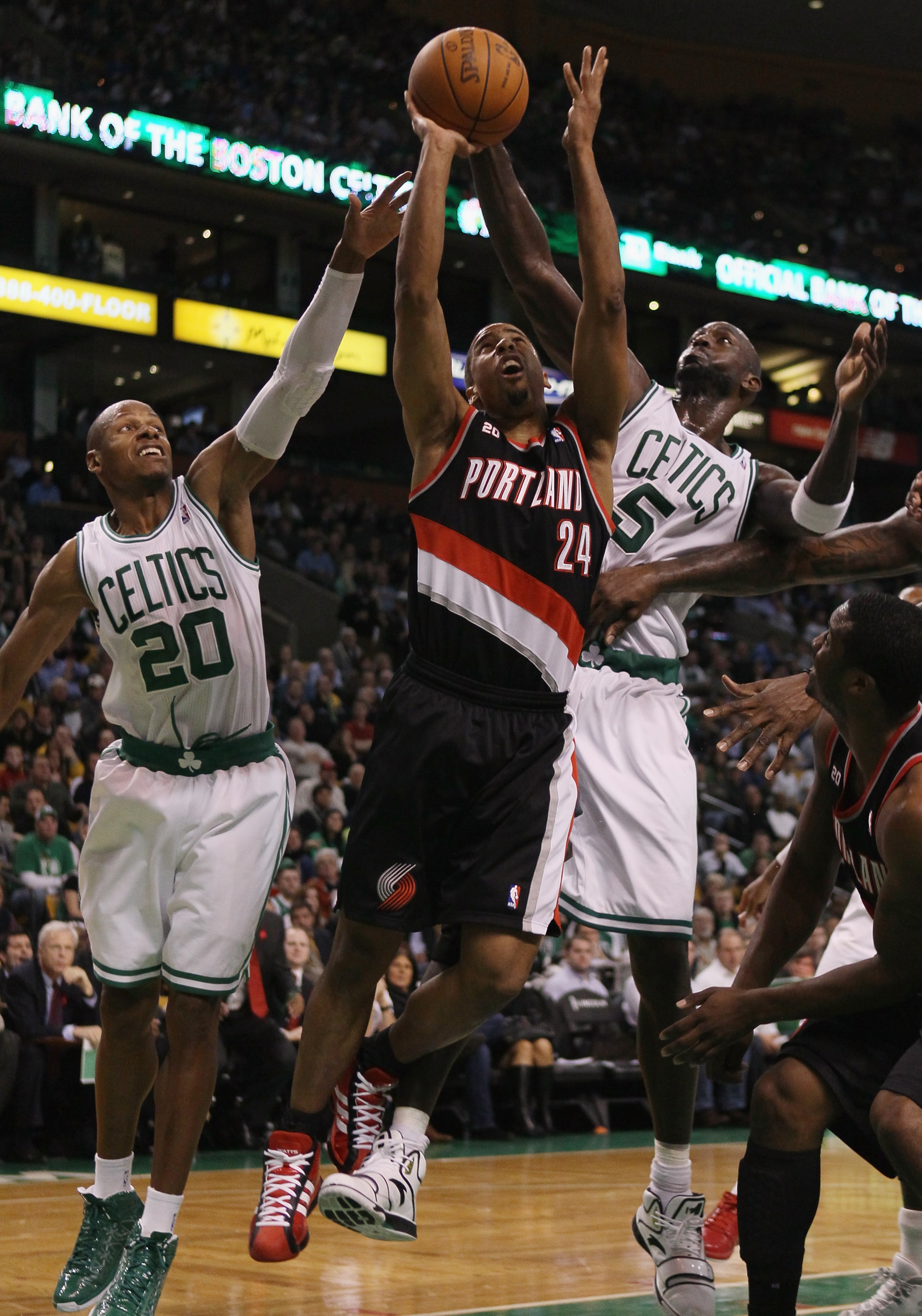 BOSTON - DECEMBER 01:  Andre Miller #24 of the Portland Trailblazers heads for the basket as Ray Allen #20 and Kevin Garnett #5 of the Boston Celtics defend on December 1, 2010 at the TD Garden in Boston, Massachusetts. The Celtics defeated the Trailblaze