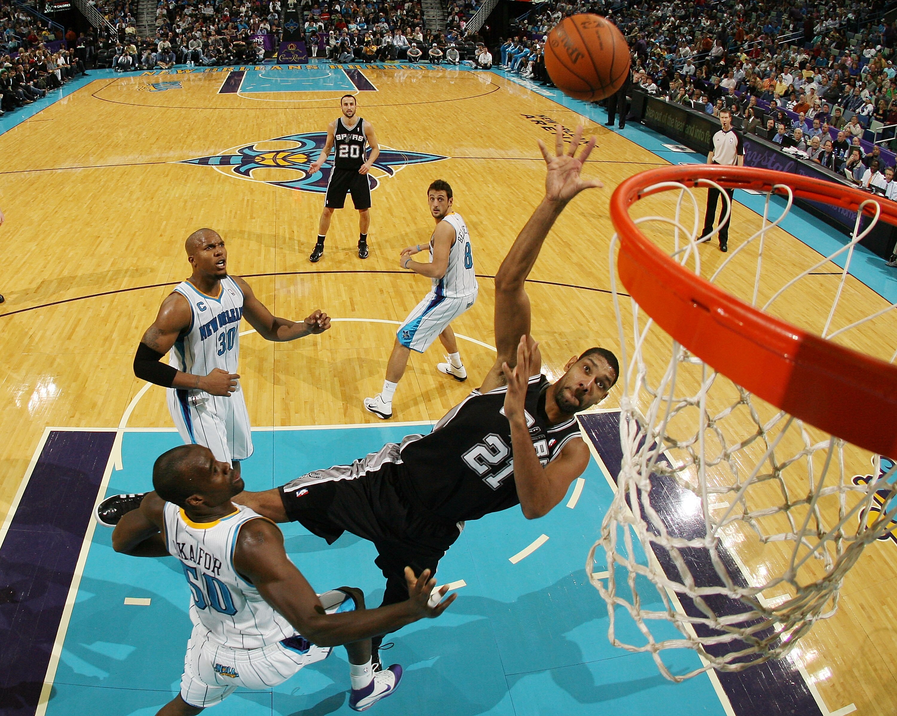 NEW ORLEANS - NOVEMBER 28:  Tim Duncan #21 of the San Antonio Spurs shoots the ball over Emeka Okafor #50 of the New Orleans Hornets at the New Orleans Arena on November 28, 2010 in New Orleans, Louisiana.  The Spurs defeated the Hornets 109-95.  NOTE TO