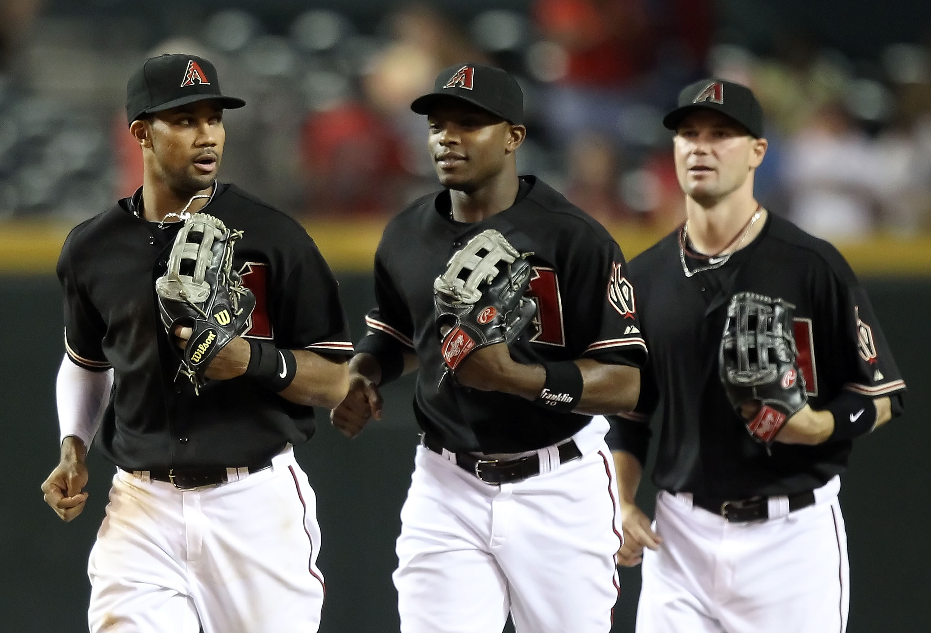 PHOENIX - JULY 10:  Outfielders Chris Young #24, Justin Upton #10 and Cole Gillespie #5 of the Arizona Diamondbacks run to greet teammates after defeating the Florida Marlins in the Major League Baseball game at Chase Field on July 10, 2010 in Phoenix, Ar