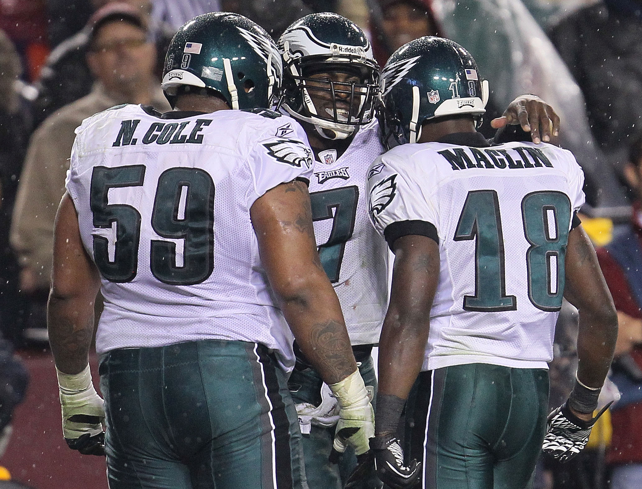 LANDOVER, MD - NOVEMBER 15:  Michael Vick #7 of the Philadelphia Eagles celebrates his second touchdown with team mates Nick Cole #59 and Jeremy Maclin #18 against the Washington Redskins on November 15, 2010 at FedExField in Landover, Maryland.  (Photo b