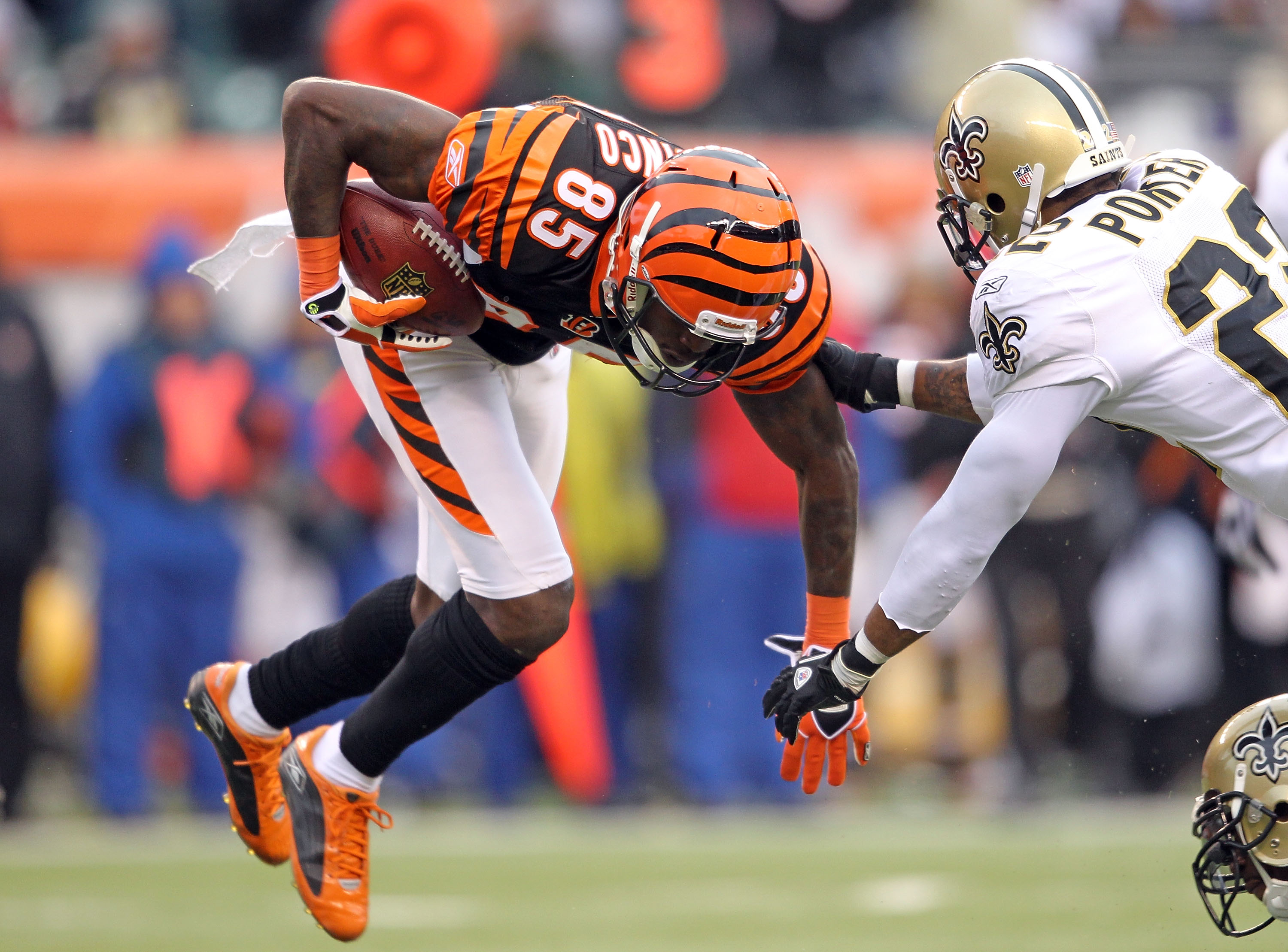 CINCINNATI, OH - DECEMBER 05:  Chad Ochocinco #85 of the Cincinnati Bengals is tackled by Tracy Porter#22 of the New Orleans Saints during the NFL game at Paul Brown Stadium on December 5, 2010 in Cincinnati, Ohio.  The Saints won 34-30.  (Photo by Andy L