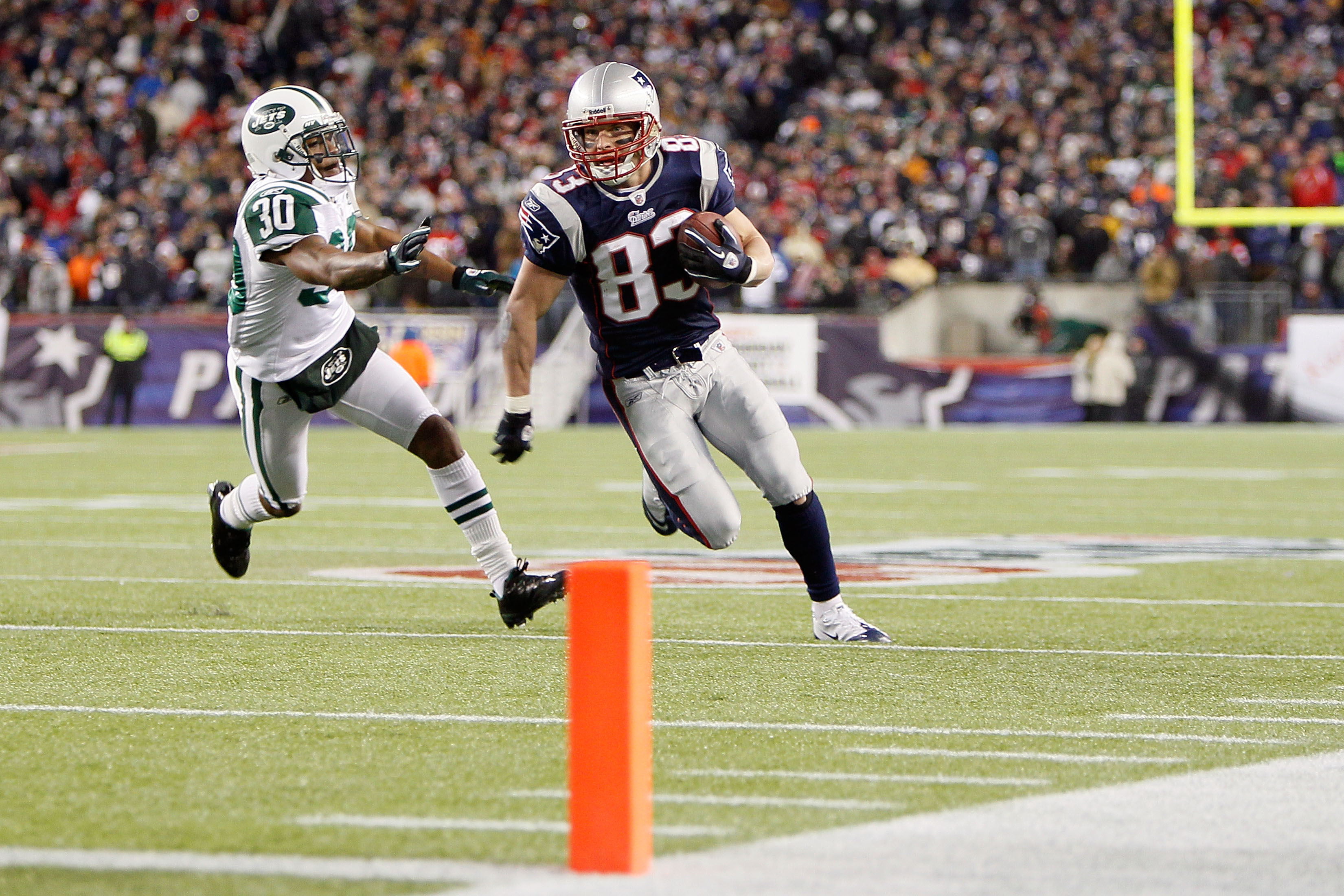 FOXBORO, MA - DECEMBER 06:  Wes Welker #83 of the New England Patriots scores an 18-yard touchdown reception in the third quarter against Drew Coleman #30 of the New York Jets at Gillette Stadium on December 6, 2010 in Foxboro, Massachusetts.  (Photo by J