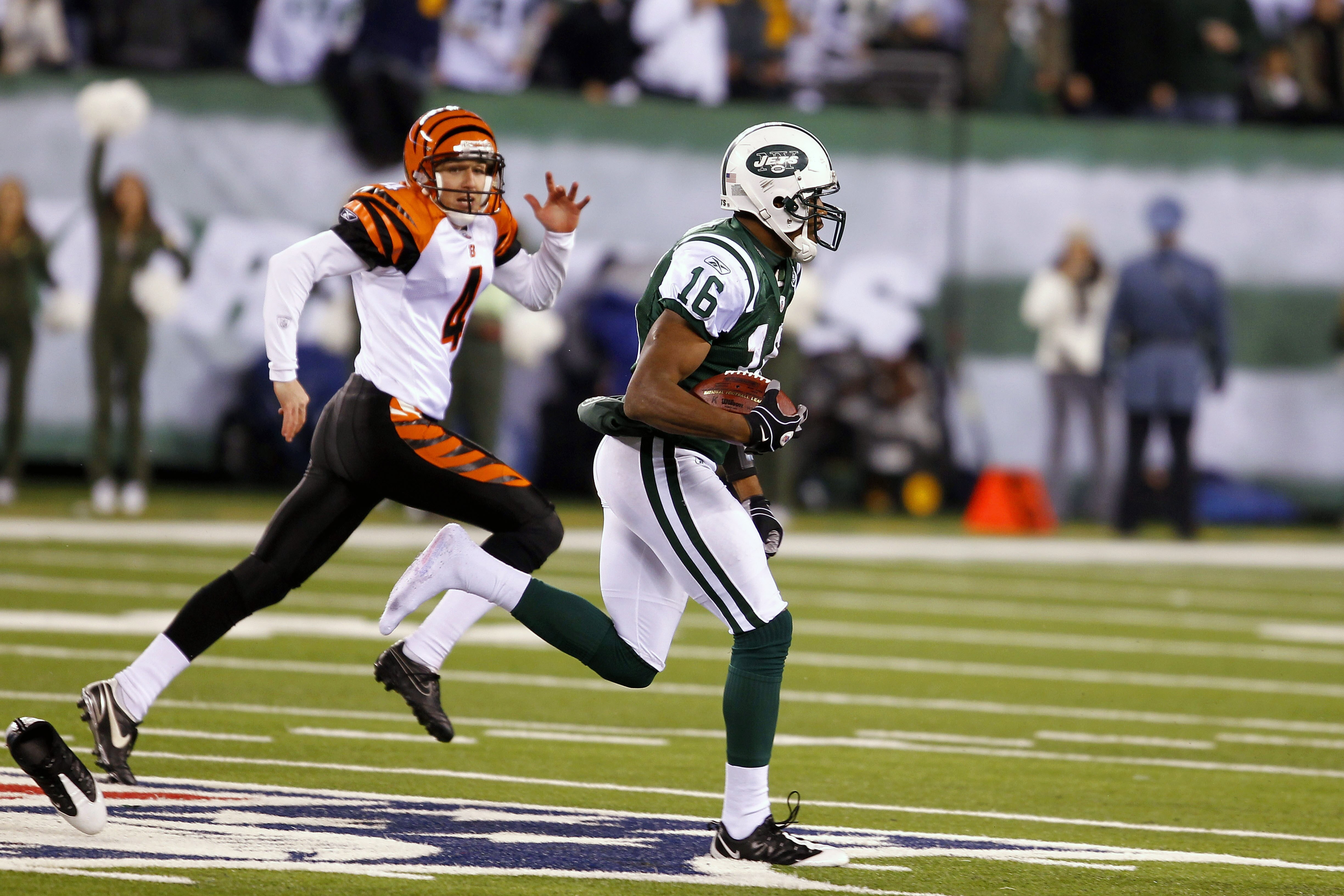 EAST RUTHERFORD, NJ - NOVEMBER 25: Brad Smith #16 of the New York Jets returns a 90 yard touchdown with one shoe past Aaron Pettrey #4 of the Cincinnati Bengals at New Meadowlands Stadium on November 25, 2010 in East Rutherford, New Jersey. The Jets defea