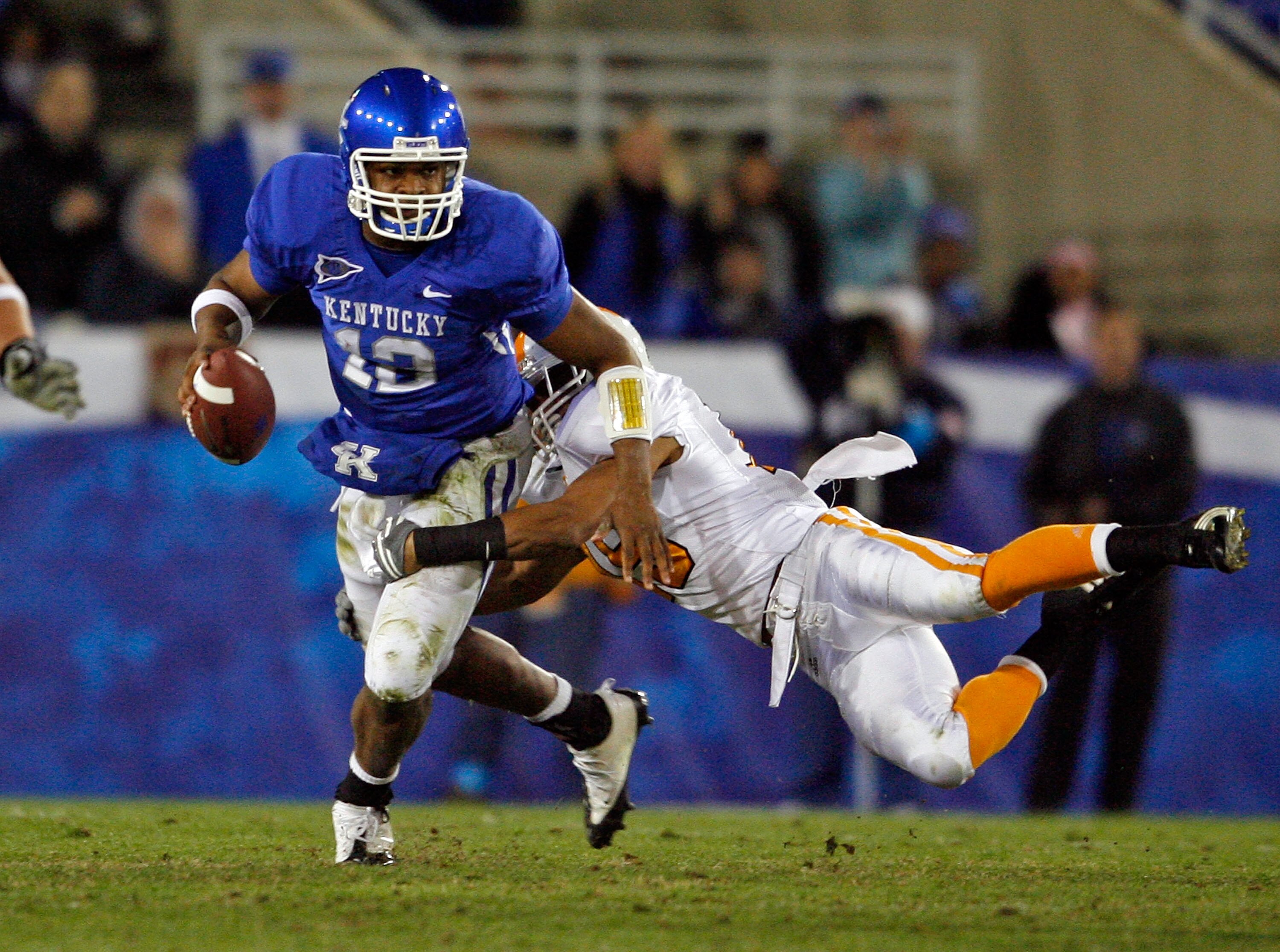 LEXINGTON, KY - NOVEMBER 28:  Morgan Newton #12 of the Kentucky Wildcats is tackled by Janzen Jackson #15 of the Tennessee Volunteers during the SEC game at Commonwealth Stadium on November 28, 2009 in Lexington, Kentucky.  (Photo by Andy Lyons/Getty Imag