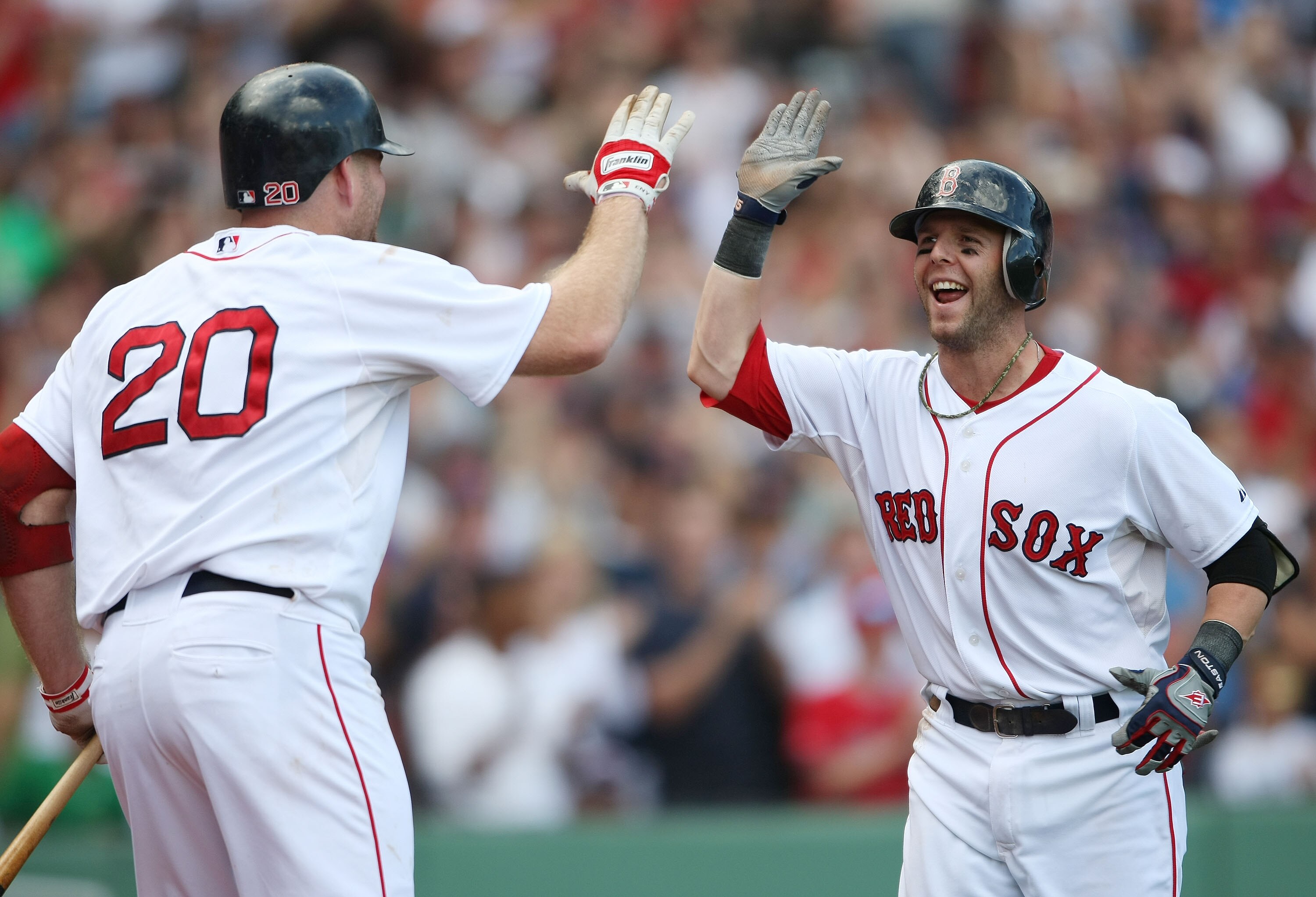 BOSTON - SEPTEMBER 13:  Dustin Pedroia #15 of the Boston Red Sox is congratulated by Kevin Youkils #20 after Pedroia hit a two run home run in the eighth inning against the Tampa Bay Rays on September 13, 2009 at Fenway Park in Boston, Massachusetts.  (Ph