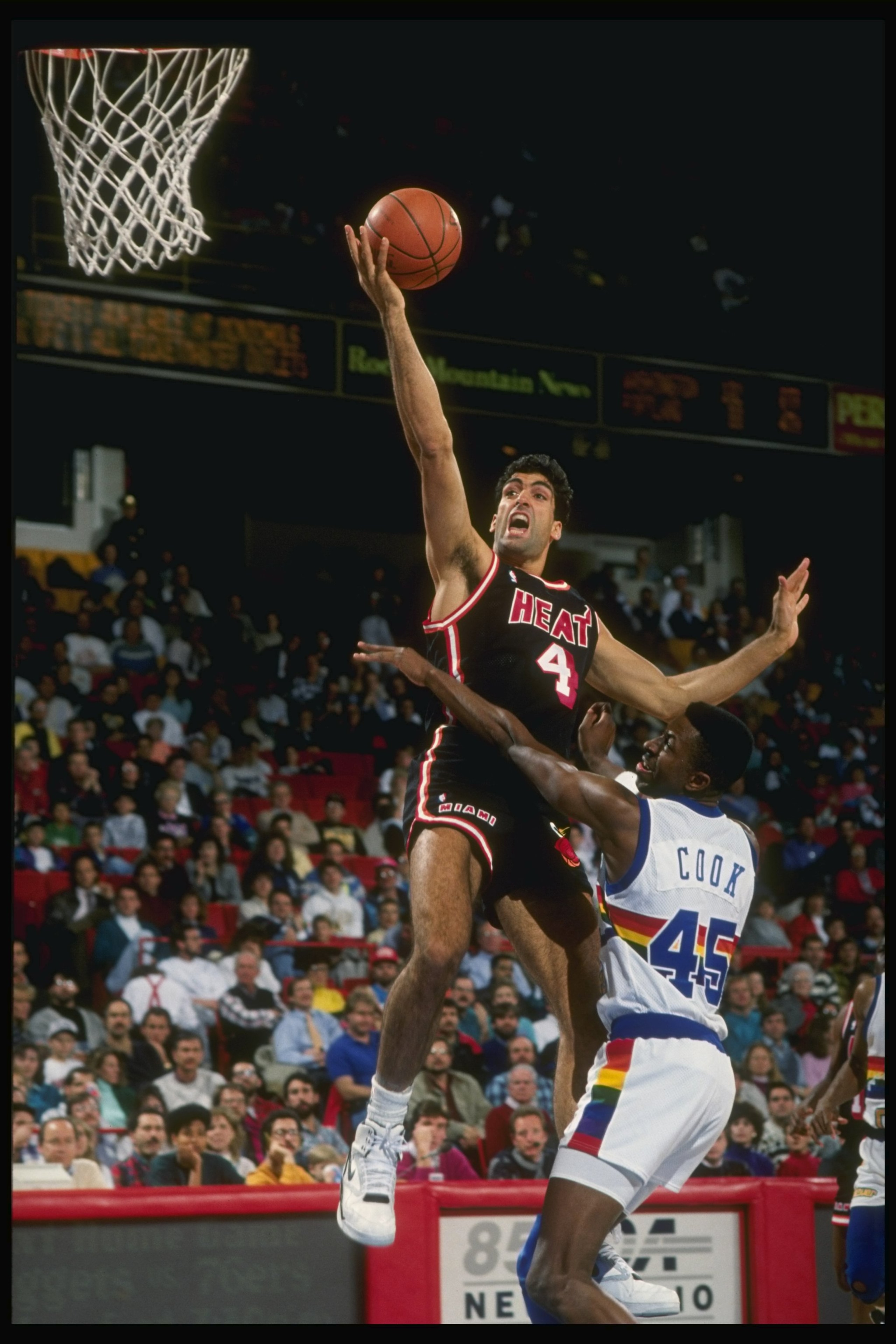 1989:  Center Rony Seikaly of the Miami Heat (left)goes up for the layup past against forward Anthony Cook of the Denver Nuggets during a game at the McNichols Arena in Denver, Colorado. Mandatory Credit: Tim de Frisco  /Allsport