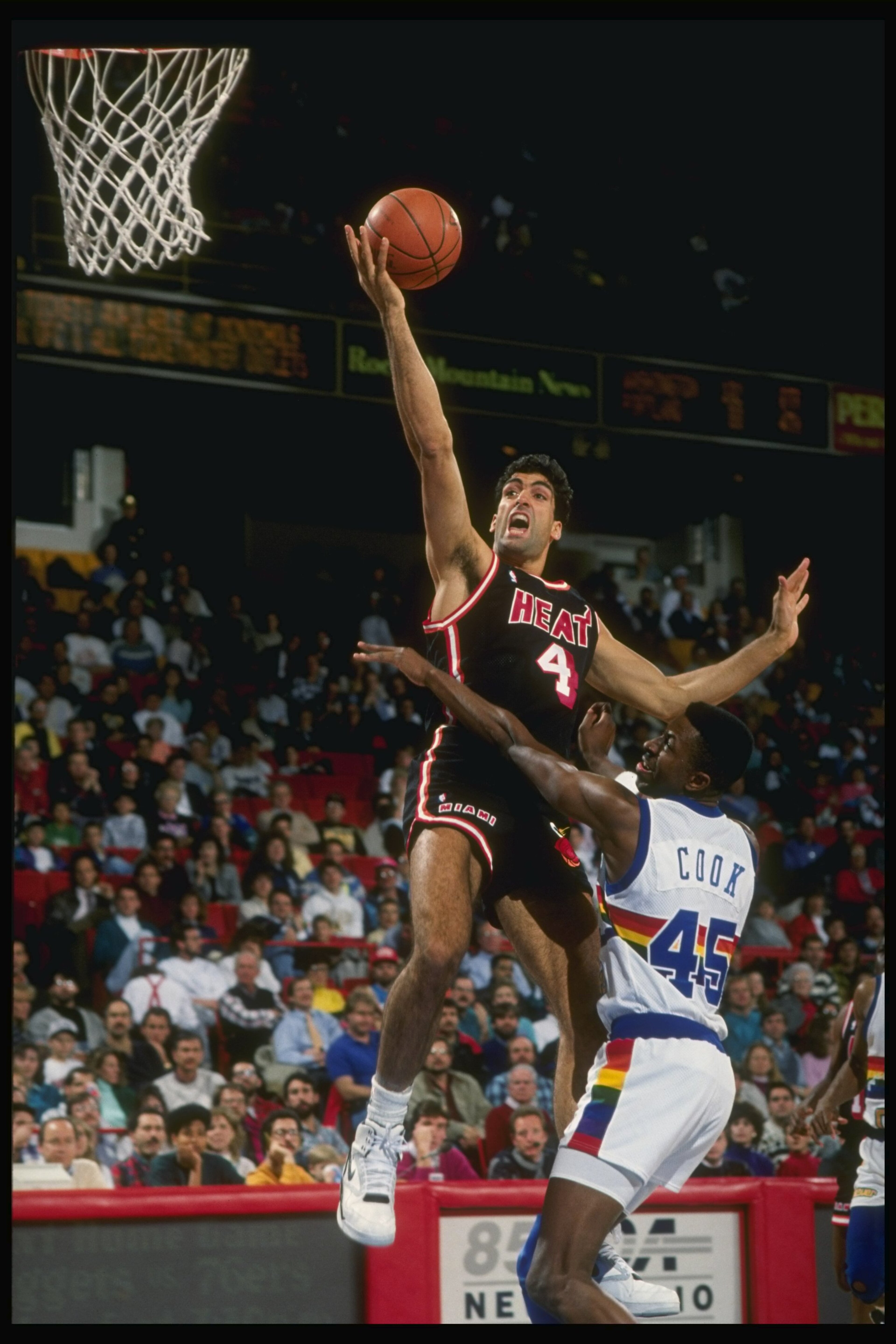 1989:  Center Rony Seikaly of the Miami Heat (left)goes up for the layup past against forward Anthony Cook of the Denver Nuggets during a game at the McNichols Arena in Denver, Colorado. Mandatory Credit: Tim de Frisco  /Allsport