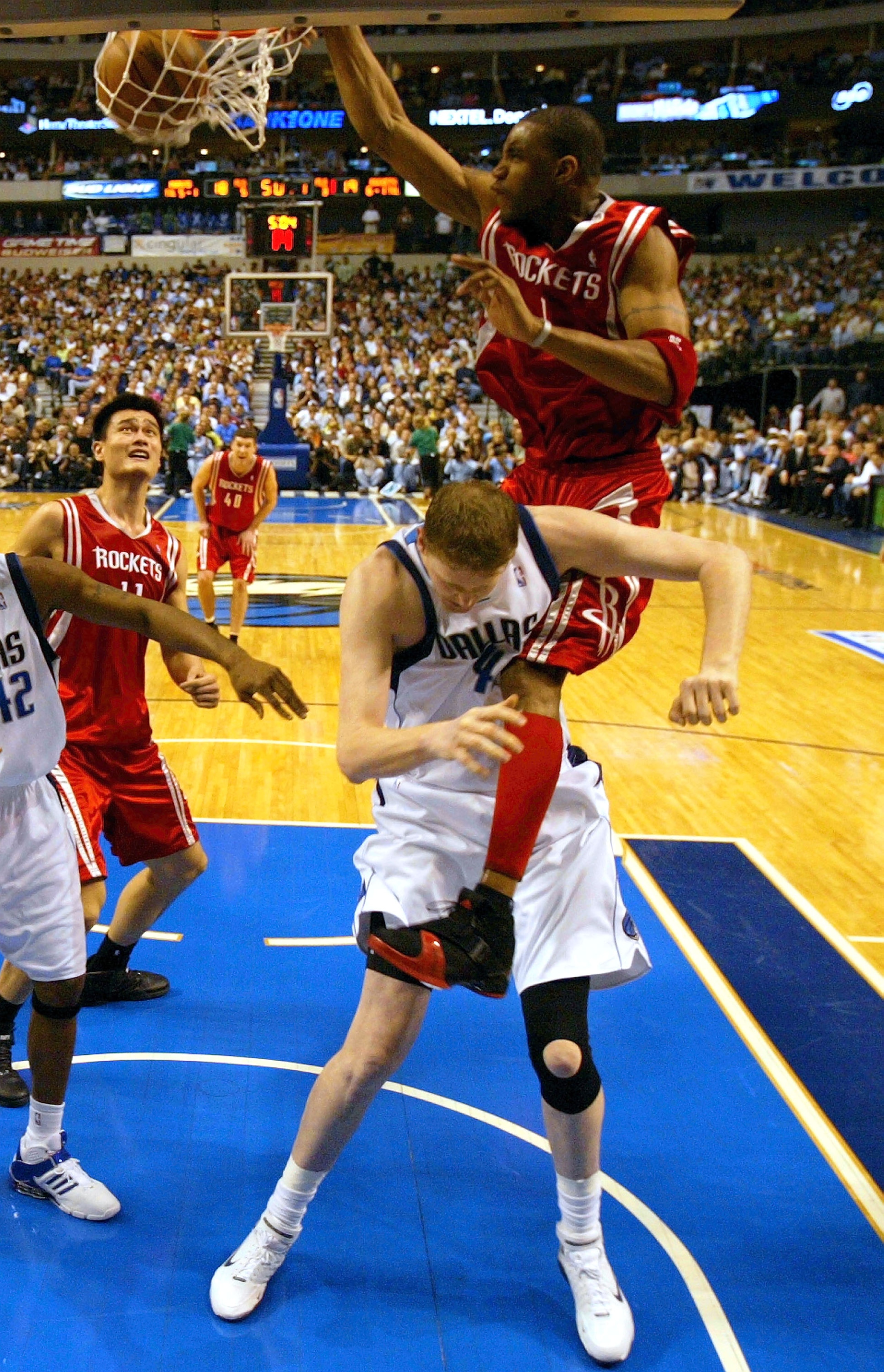 DALLAS - APRIL 25:  Forward Tracy McGrady #1 of the Houston Rockets makes the slam dunk on top of Shawn Bradley #44 of the Dallas Mavericks in Game two of the Western Conference Quarterfinals during the 2005 NBA Playoffs on April 25, 2005 at the American