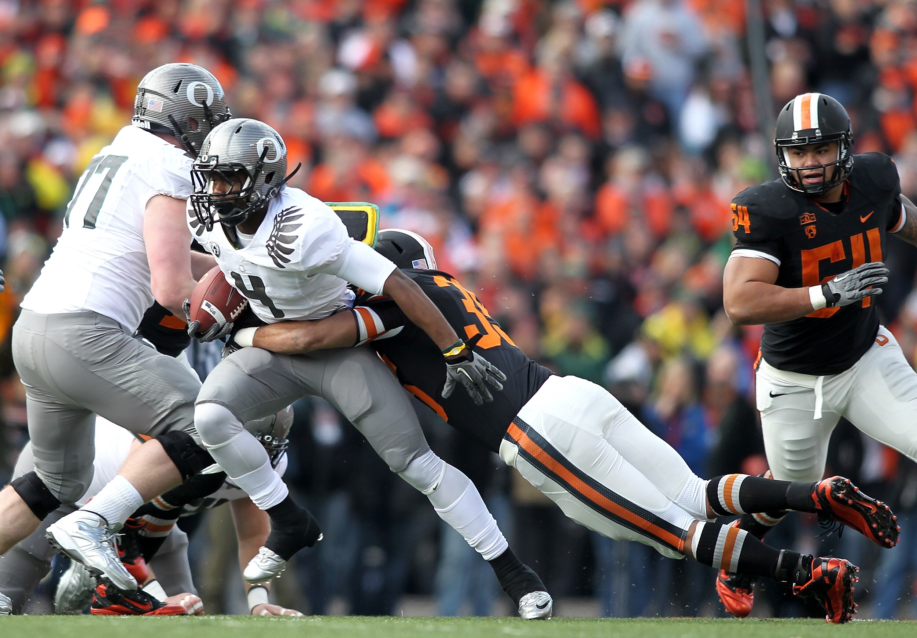 CORVALLIS, OR - DECEMBER 04:  Josh Huff #4 of the Oregon Ducks runs te ball against Keith Pankey #35 of the Oregon State Beavers during the 114th Civil War on December 4, 2010 at the Reser Stadium in Corvallis, Oregon.  (Photo by Jonathan Ferrey/Getty Ima