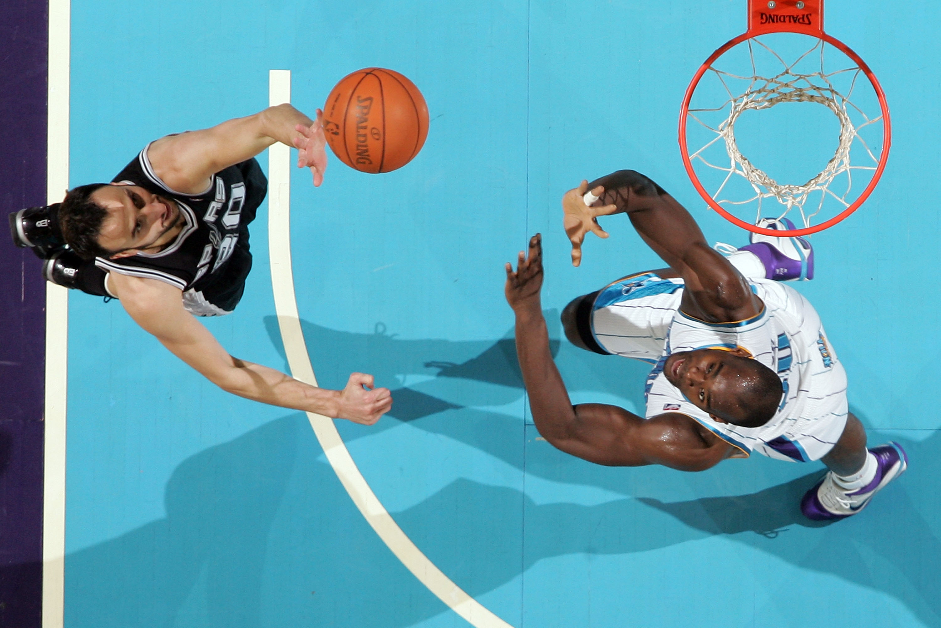 NEW ORLEANS - NOVEMBER 28:  Manu Ginobili #20 of the San Antonio Spurs shoots the ball over Emeka Okafor #50 of the New Orleans Hornets at the New Orleans Arena on November 28, 2010 in New Orleans, Louisiana.  The Spurs defeated the Hornets 109-95.  NOTE
