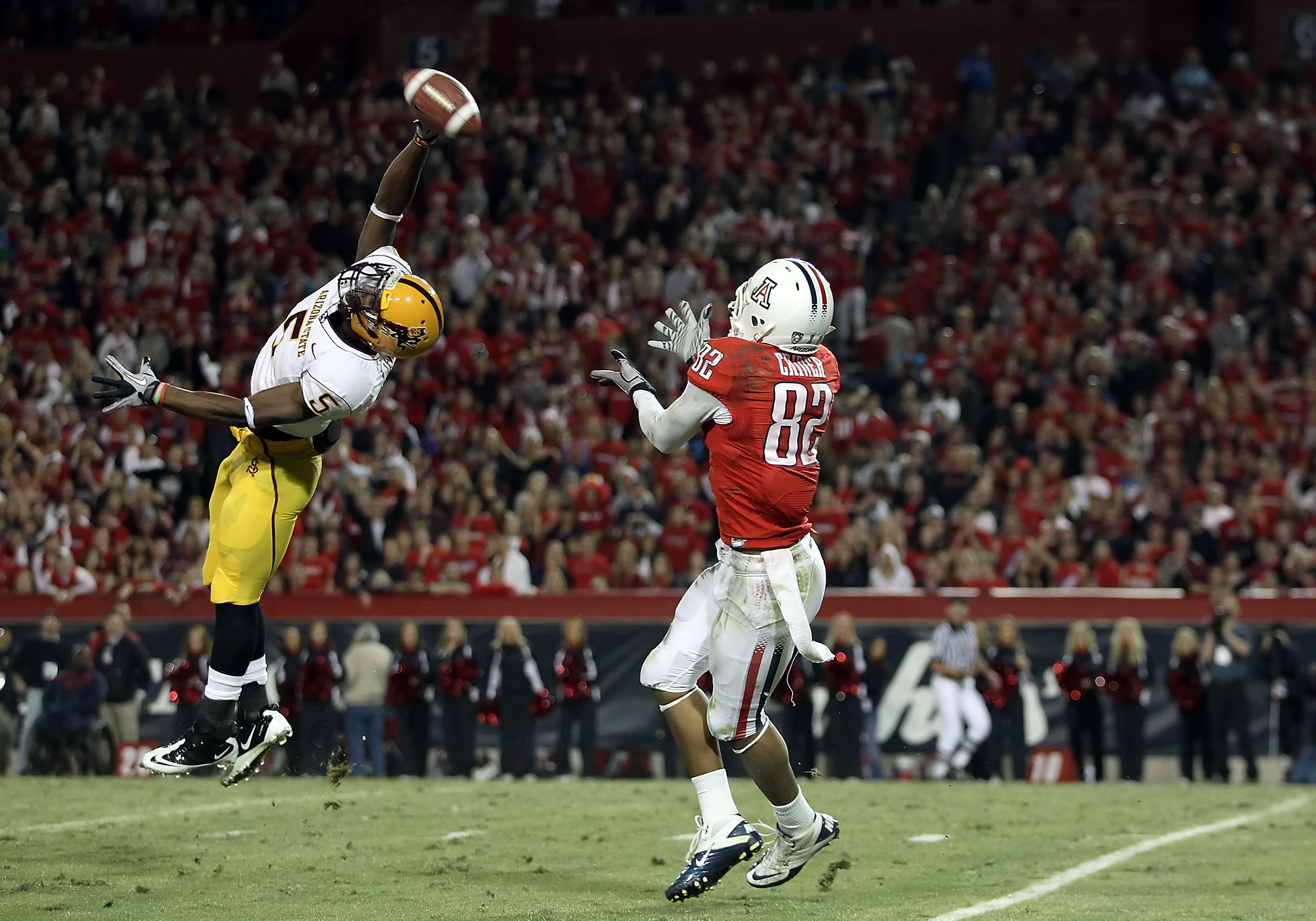 TUCSON, AZ - DECEMBER 02:  Wide receiver Juron Criner #82 of the Arizona Wildcats catches a 52 yard touchdown reception past LeQuan Lewis #5 of the Arizona State Sun Devils during the college football game at Arizona Stadium on December 2, 2010 in Tucson,