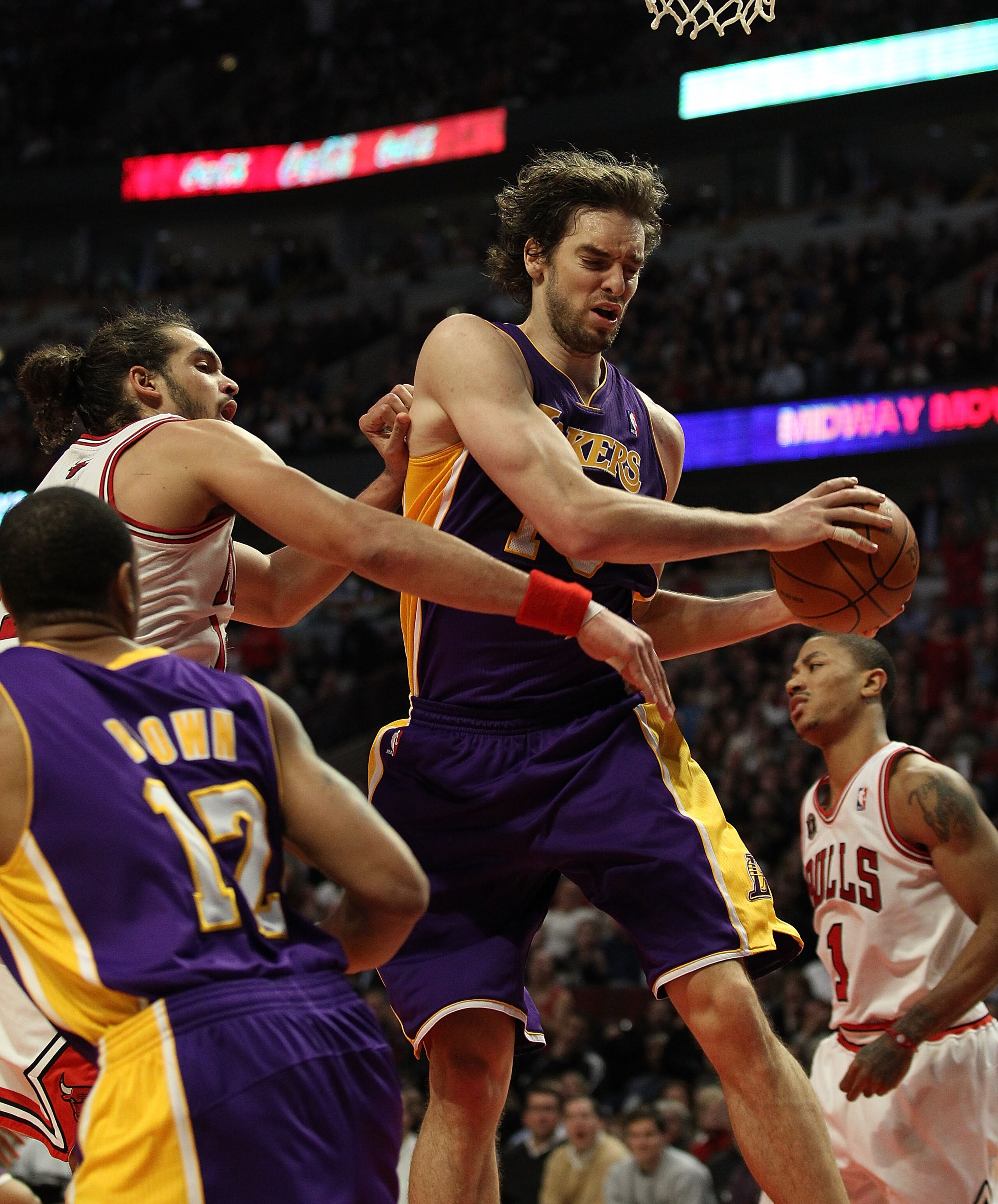 CHICAGO, IL - DECEMBER 10: Pau Gasol #16 of the Los Angeles Lakers pulls down a rebound in front of Joakim Noah #13 of the Chicago Bulls at the United Center on December 10, 2010 in Chicago, Illinois. The Bulls defeated the Lakers 88-84. NOTE TO USER: Use