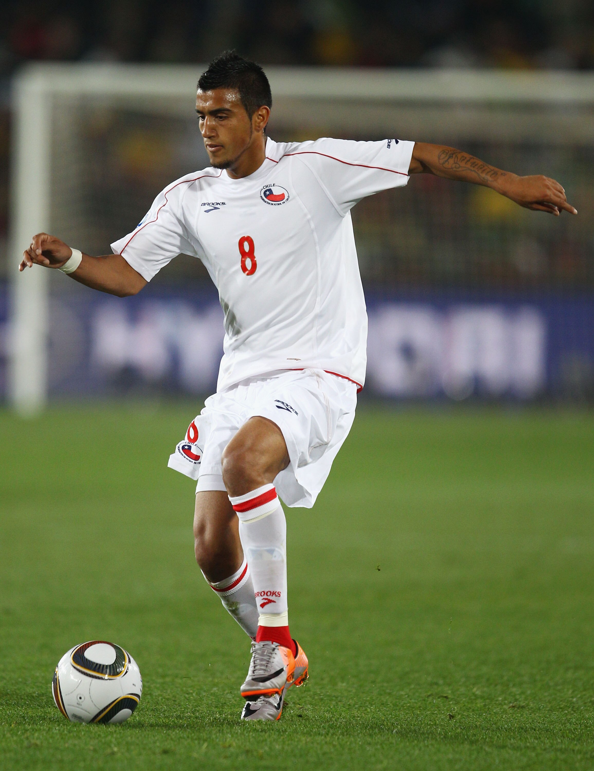 JOHANNESBURG, SOUTH AFRICA - JUNE 28:  Arturo Vidal of Chile runs with the ball during the 2010 FIFA World Cup South Africa Round of Sixteen match between Brazil and Chile at Ellis Park Stadium on June 28, 2010 in Johannesburg, South Africa.  (Photo by Ri