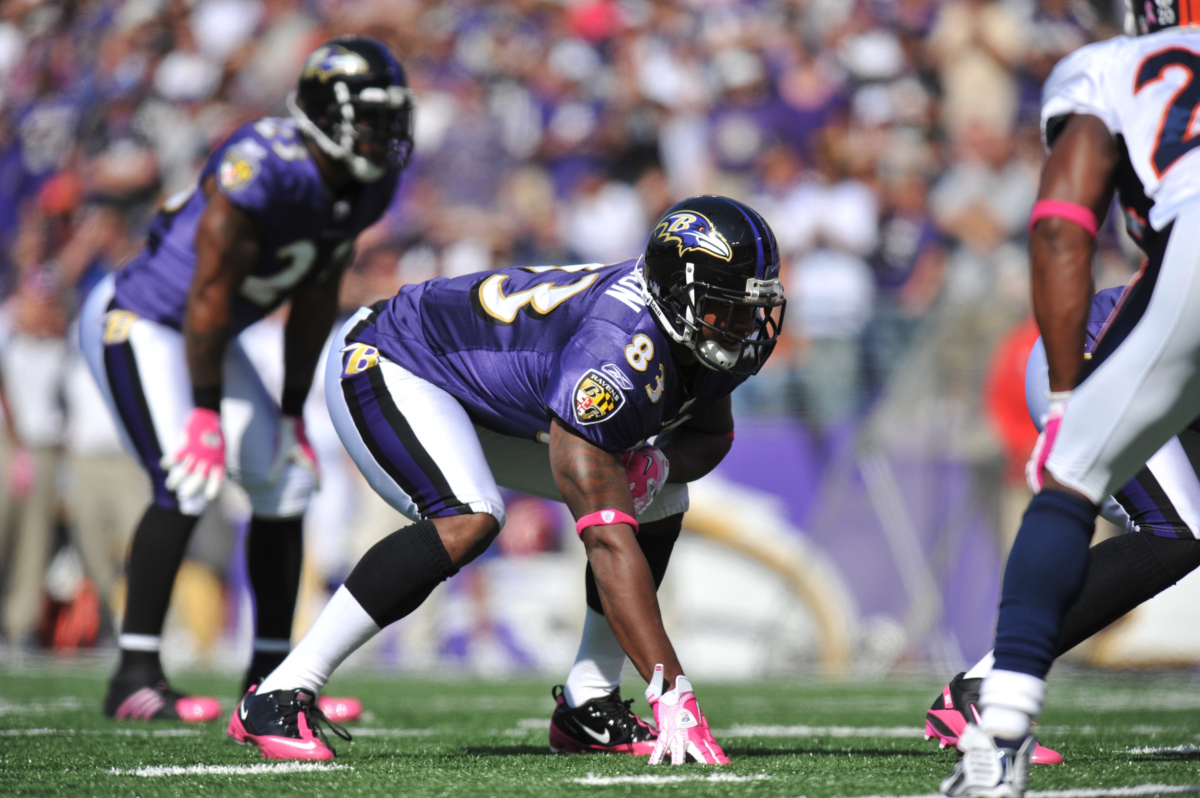 BALTIMORE, MD - OCTOBER 10: Ed Dickson #83 of the Baltimore Ravens defends against the Denver Broncos at M&T Bank Stadium on October 10, 2010 in Baltimore, Maryland. Players wore pink in recognition of Breast Cancer Awareness Month. The Ravens defeated th