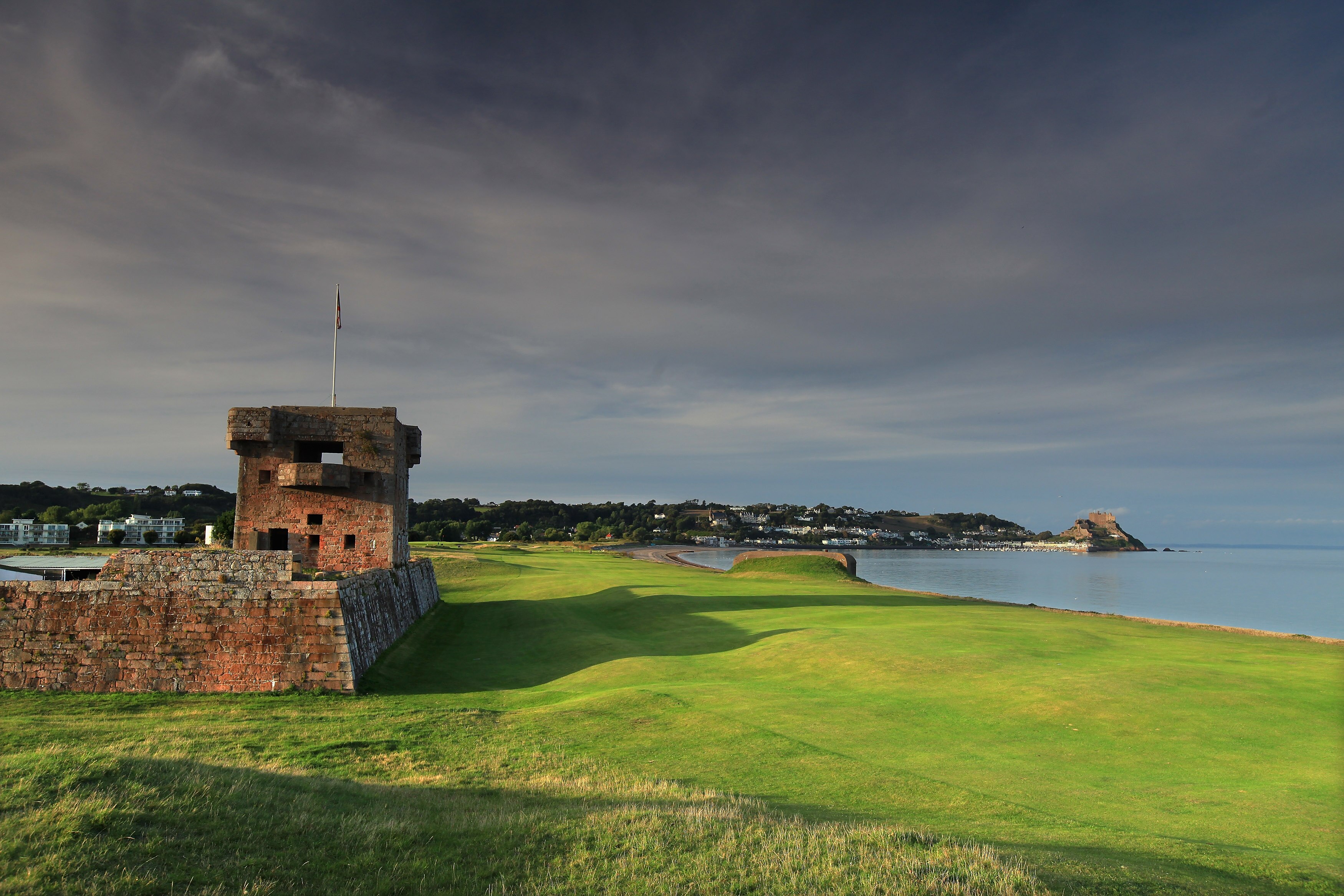 GROUVILLE, JERSEY - SEPTEMBER 19:  The 470 yards par 5, 1st hole that runs between the bay and the sea defences from World War II and Fort Henry on the left at The Royal Jersey Golf Club on September 19, 2010 in Grouville, Jersey, Channel Islands.  (Photo