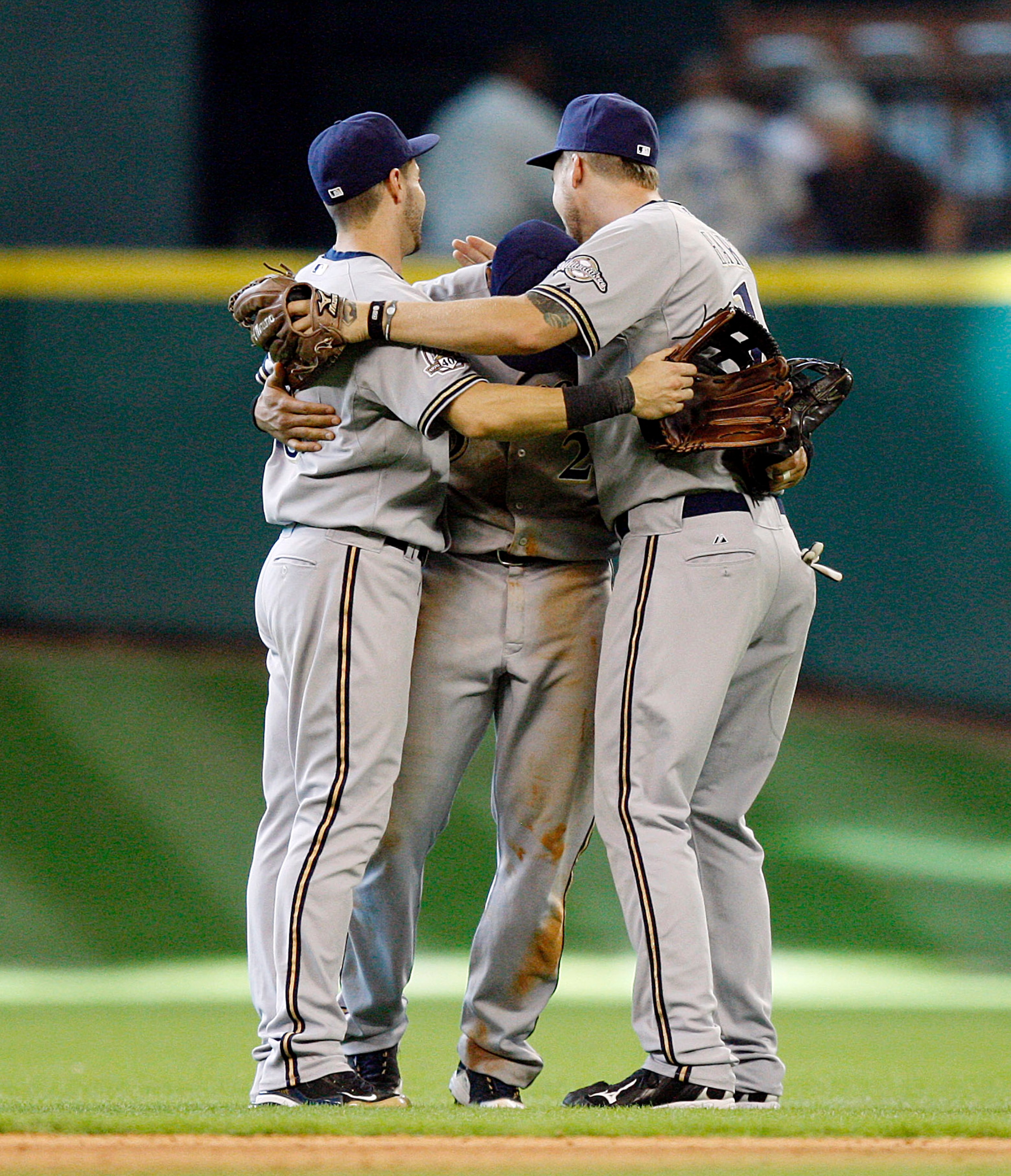 HOUSTON - SEPTEMBER 15:  Carlos Gomez, center, Ryan Braun, left, and Corey Hart of the Milwaukee Brewers celebrate their win over the Houston Astros 8-6 in ten innings at Minute Maid Park on September 15, 2010 in Houston, Texas.  (Photo by Bob Levey/Getty