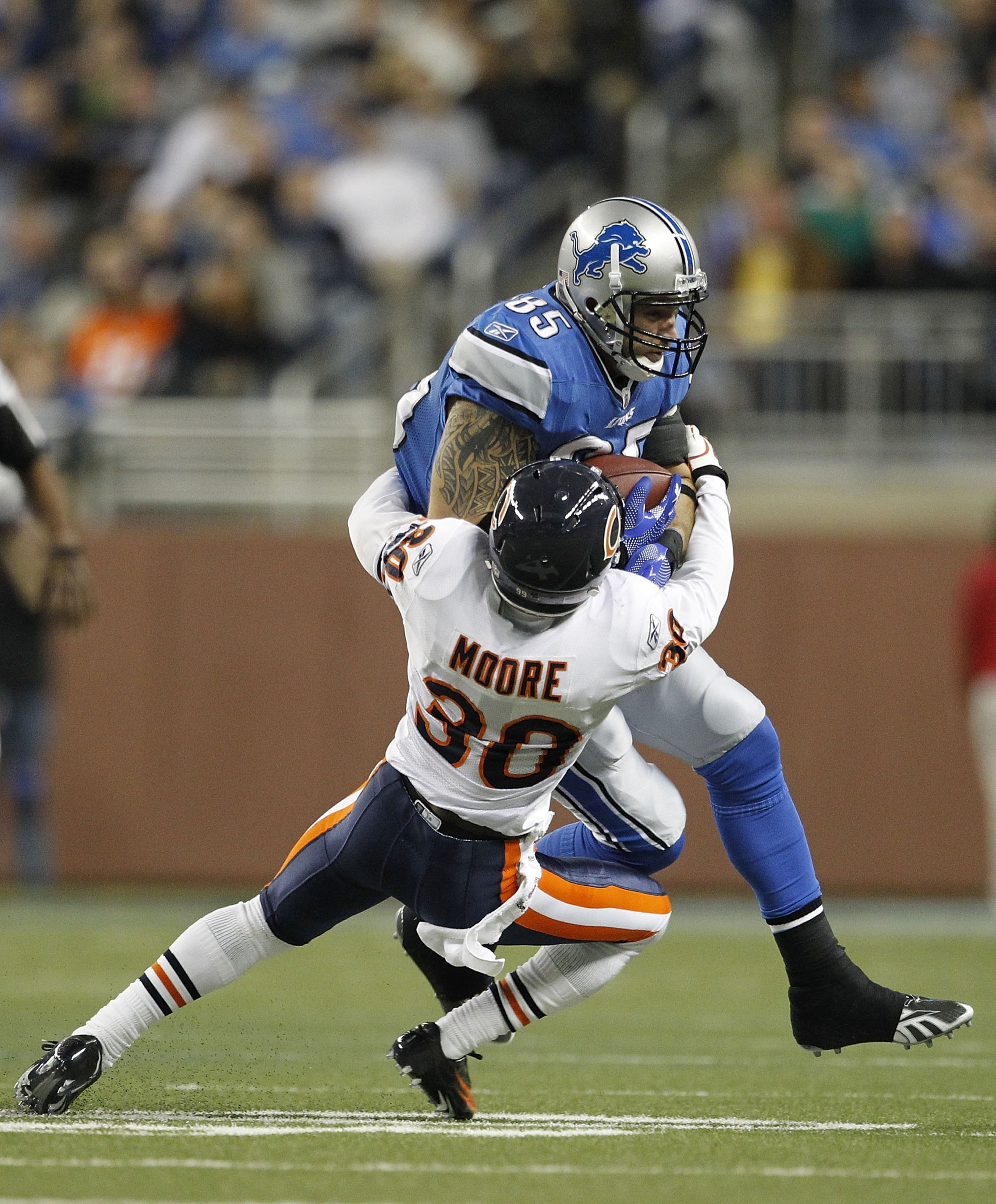 DETROIT - DECEMBER 05: D. J. Moore #30 of the Chicago Bears stops Tony Scheffler #85 of the Detroit Lions during the fourth quarter of the game at Ford Field on December 5, 2010 in Detroit, Michigan. The Bears defeated the Lions 24-20. (Photo by Leon Hali