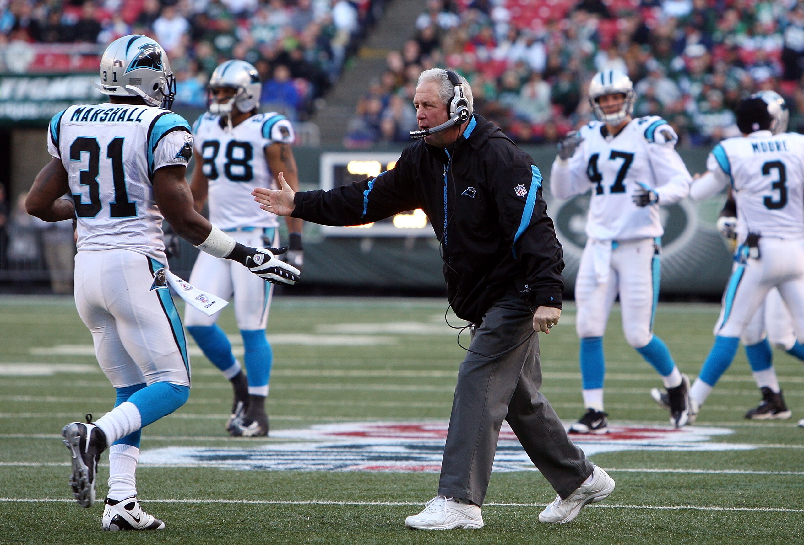 EAST RUTHERFORD, NJ - NOVEMBER 29:  Head coach John Fox of the Carolina Panthers congratulates Richard Marshall #31 on his fumble reconery against the New York Jets on November 29, 2009 at Giants Stadium in East Rutherford, New Jersey. The Jets defeated t