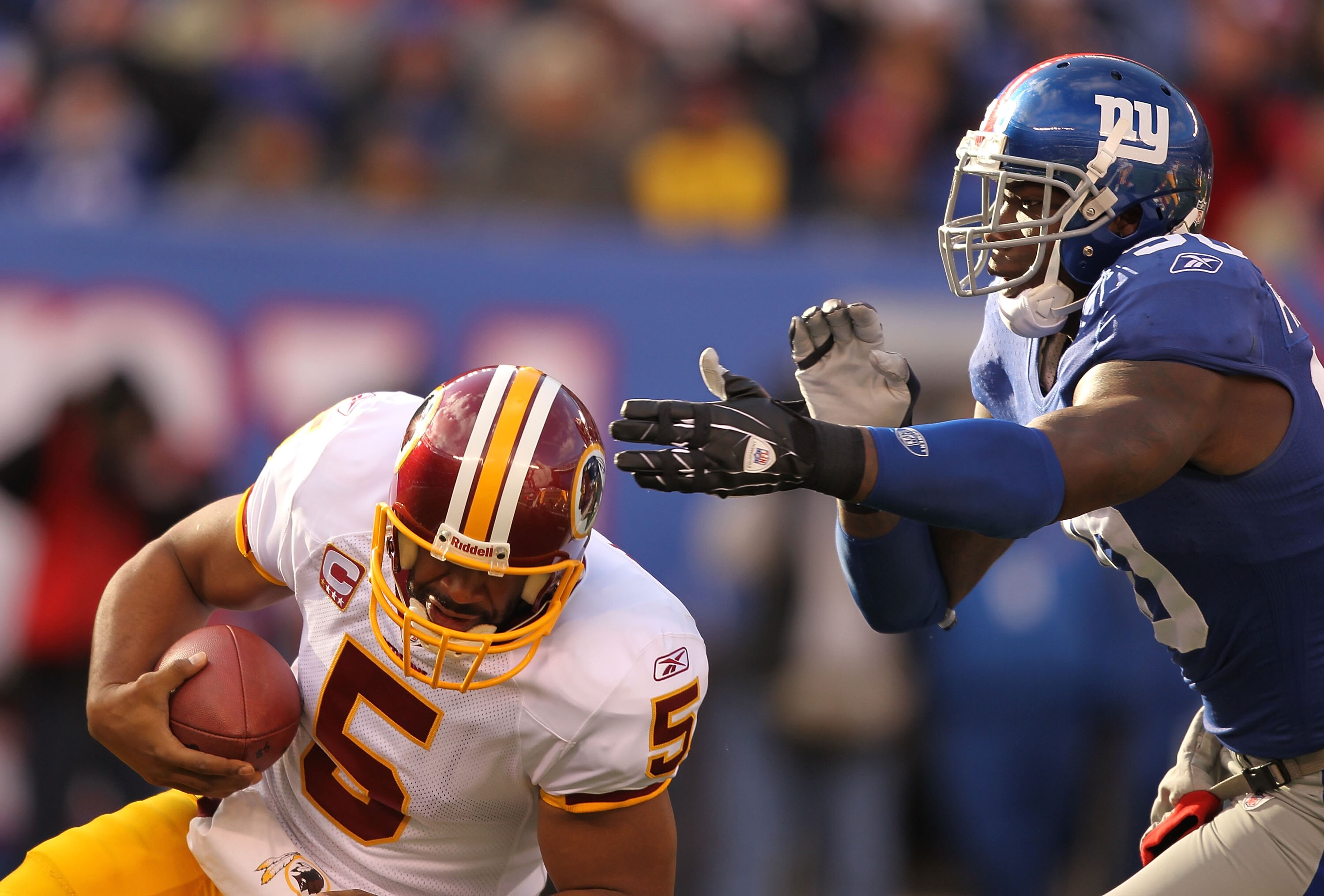 EAST RUTHERFORD, NJ - DECEMBER 05:  Jason Pierre Paul #90 of the New York Giants Sacks Donovan McNabb #5 of the Washington Redskins during their game on December 5, 2010 at The New Meadowlands Stadium in East Rutherford, New Jersey.  (Photo by Al Bello/Ge