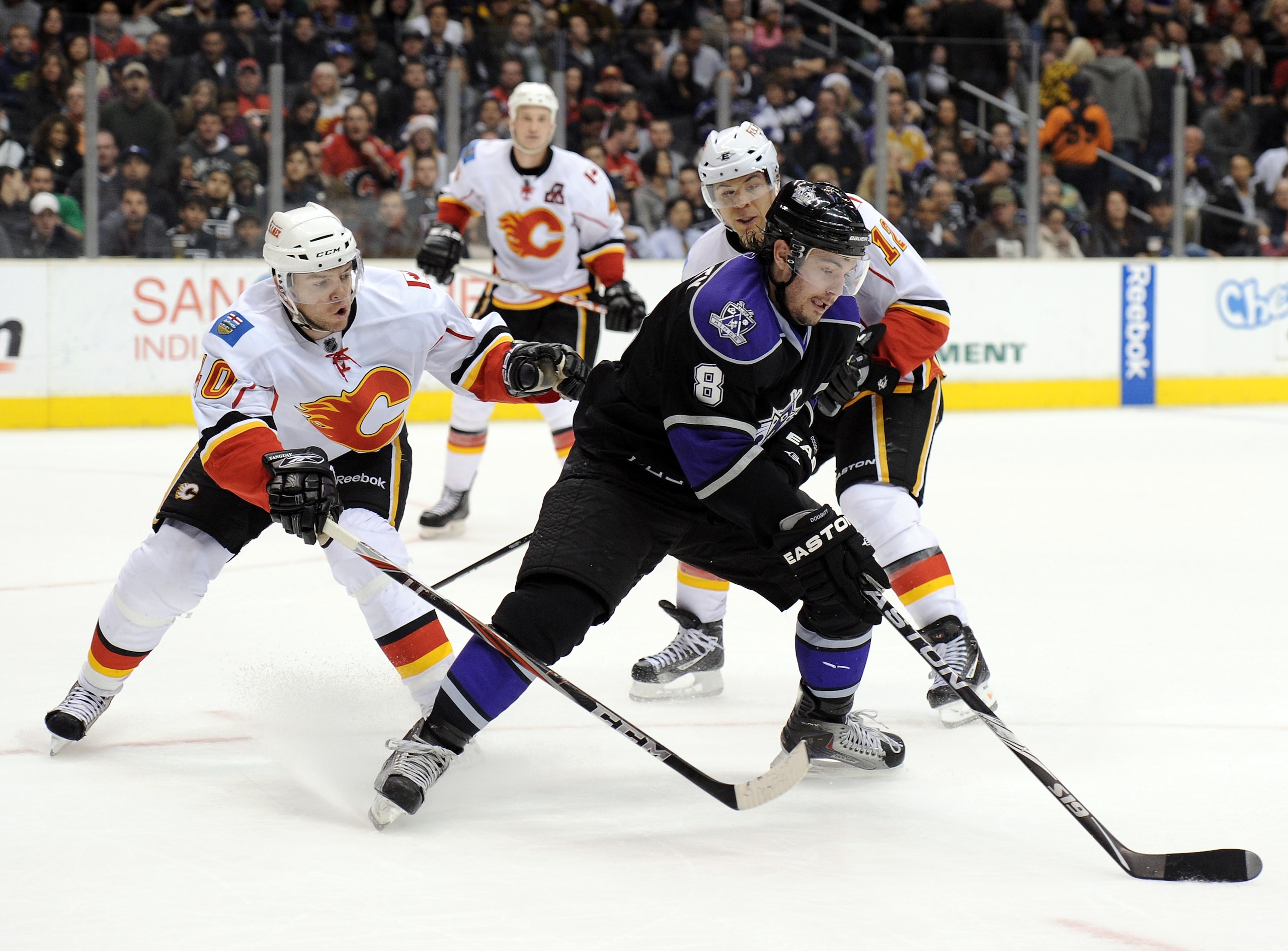 LOS ANGELES, CA - DECEMBER 09: Drew Doughty #8 of the Los Angeles Kings turns to shoot the puck in front of Alex Tanguay #40 and Jarome Iginla #12 of the Calgary Flames during the second period at the Staples Center on December 9, 2010 in Los Angeles, Ca LOS ANGELES, CA - DECEMBER 09: Drew Doughty #8 of the Los Angeles Kings turns to shoot the puck in front of Alex Tanguay #40 and Jarome Iginla #12 of the Calgary Flames during the second period at the Staples Center on December 9, 2010 in Los Angeles, Ca