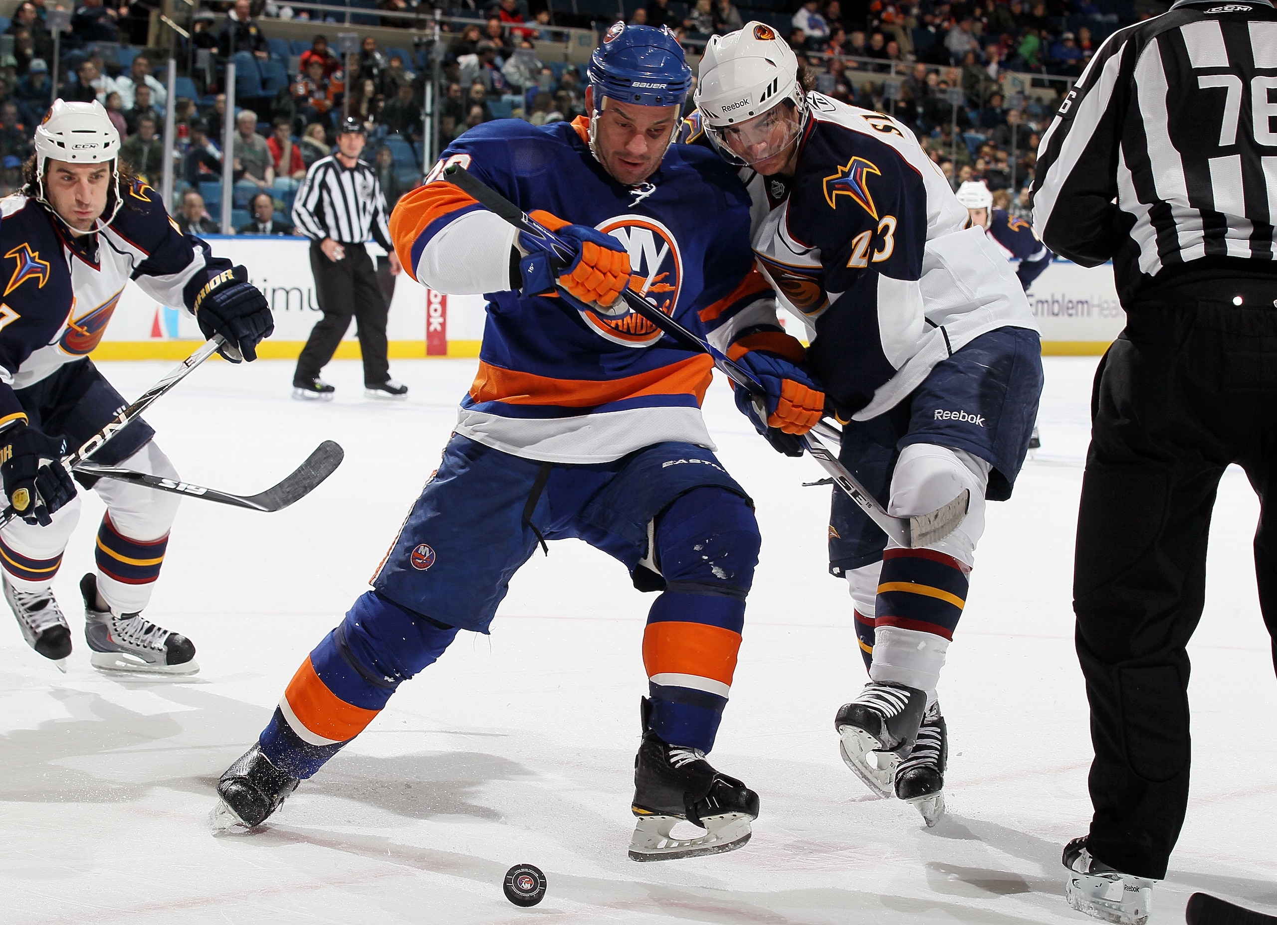 UNIONDALE, NY - DECEMBER 11:  Zenon Konopka #28 of the New York Islanders wins a face off from Jim Slater #23 of the Atlanta Thrashers on December 11, 2010 at Nassau Coliseum in Uniondale, New York.  (Photo by Jim McIsaac/Getty Images)