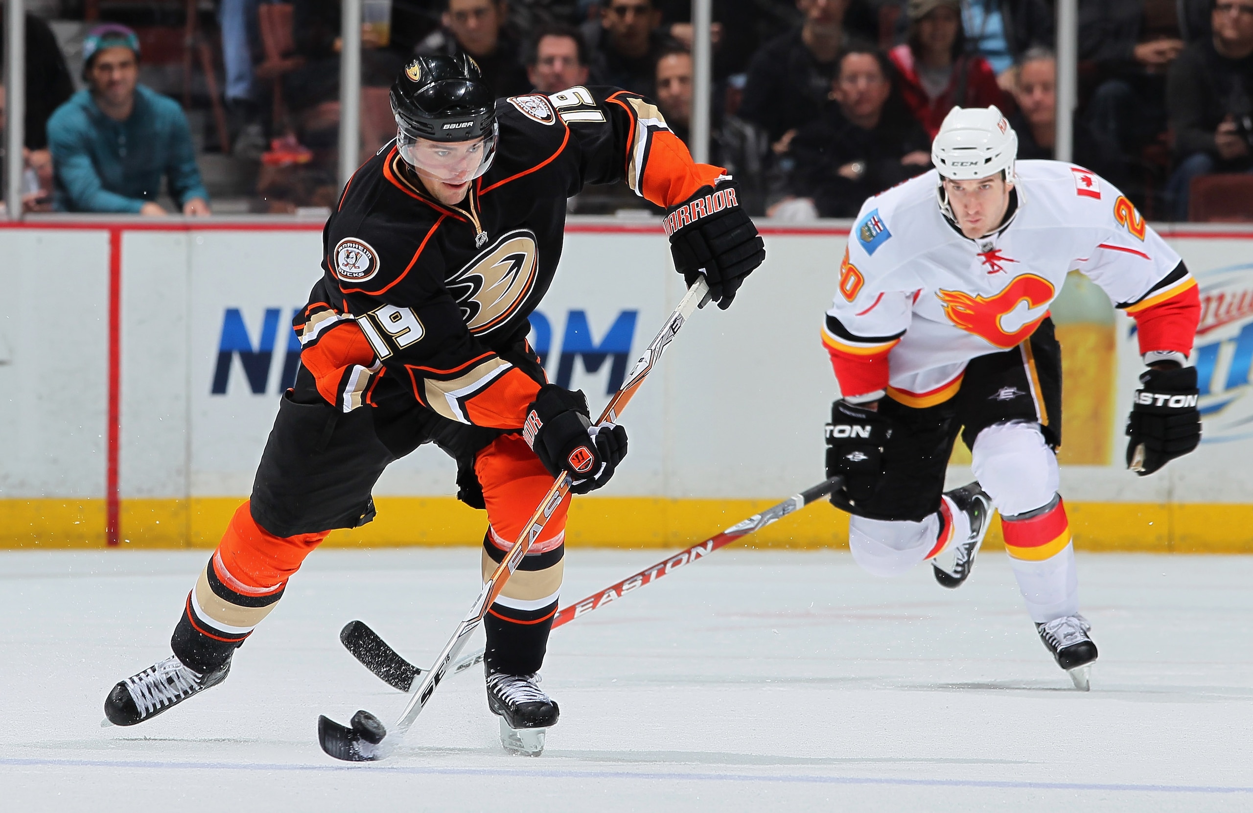 ANAHEIM, CA - DECEMBER 10:  Joffrey Lupul #19 of the Anaheim Ducks is pursued by Curtis Glencross #40 of the Calgary Flames for the puck in the third period at the Honda Center on December 10, 2010 in Anaheim, California. The Ducks defeated the Flames 3-2