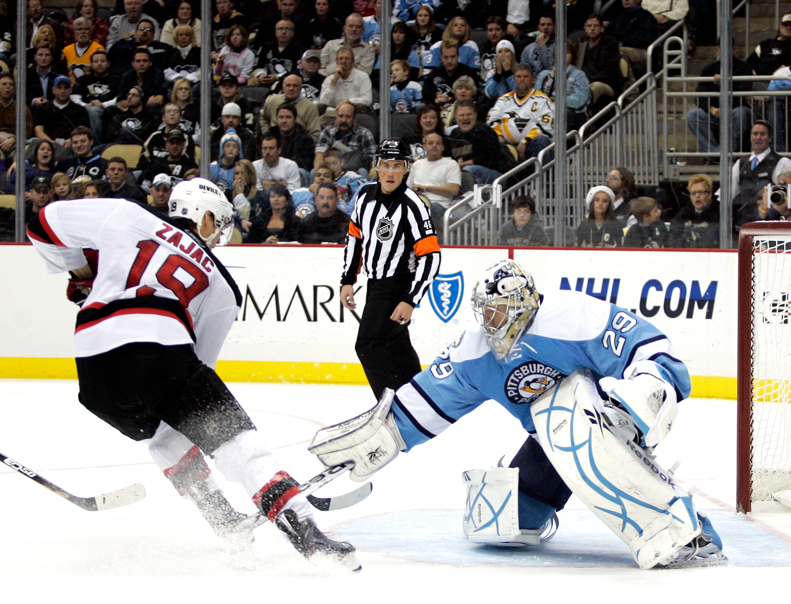 PITTSBURGH, PA - DECEMBER 06:  Marc-Andre Fleury #29 of the Pittsburgh Penguins poke checks Travis Zajac #19 of the New Jersey Devils at Consol Energy Center on December 6, 2010 in Pittsburgh, Pennsylvania.  (Photo by Justin K. Aller/Getty Images)