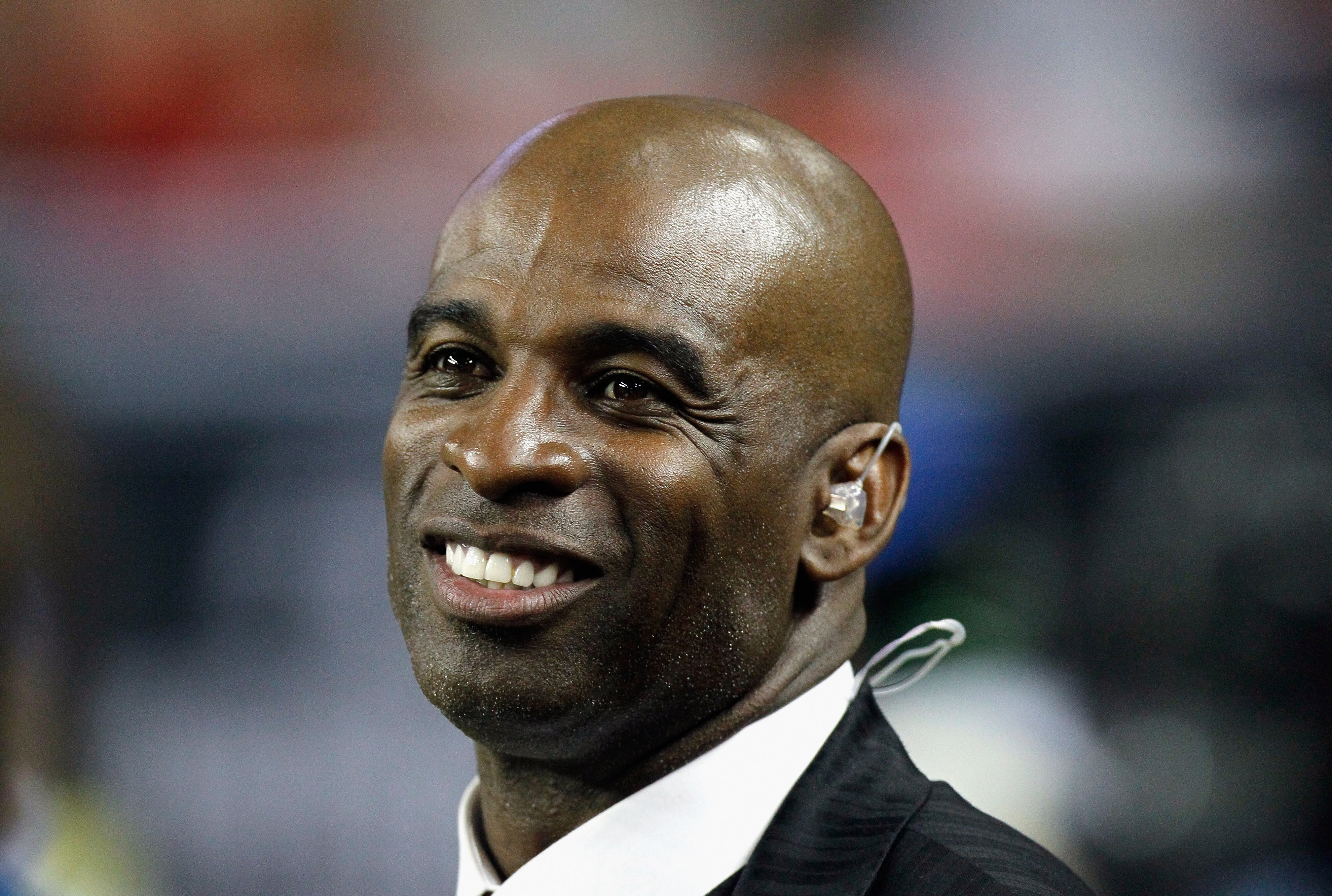 ATLANTA - NOVEMBER 11:  NFL network broadcaster and former Atlanta Falcons player Deion Sanders watches from the sidelines after being inducted into the Falcons Ring of Honor during halftime of the game against the Baltimore Ravens at Georgia Dome on Nove